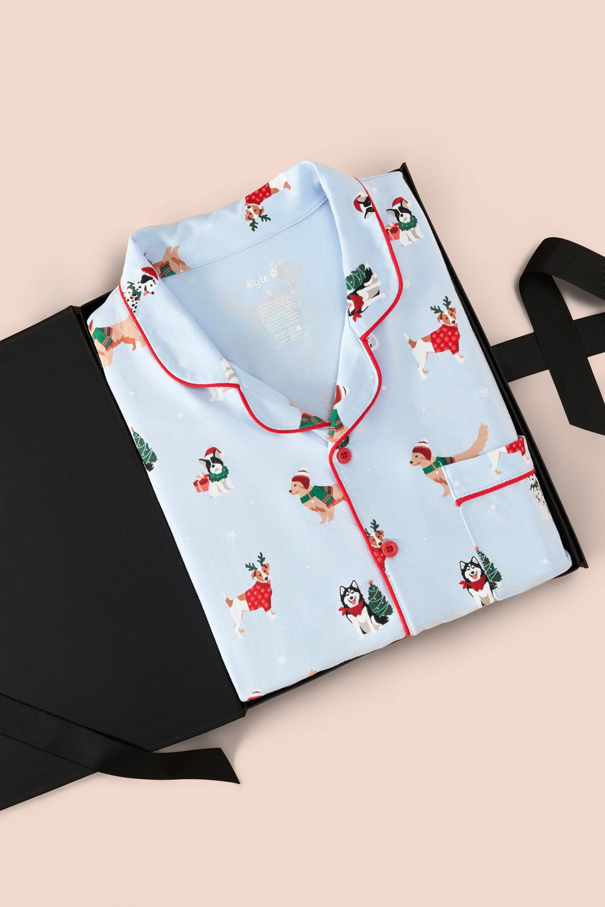 Men's Long Sleeve Pajama Set in Holiday Pups print packed in a box on a beige background