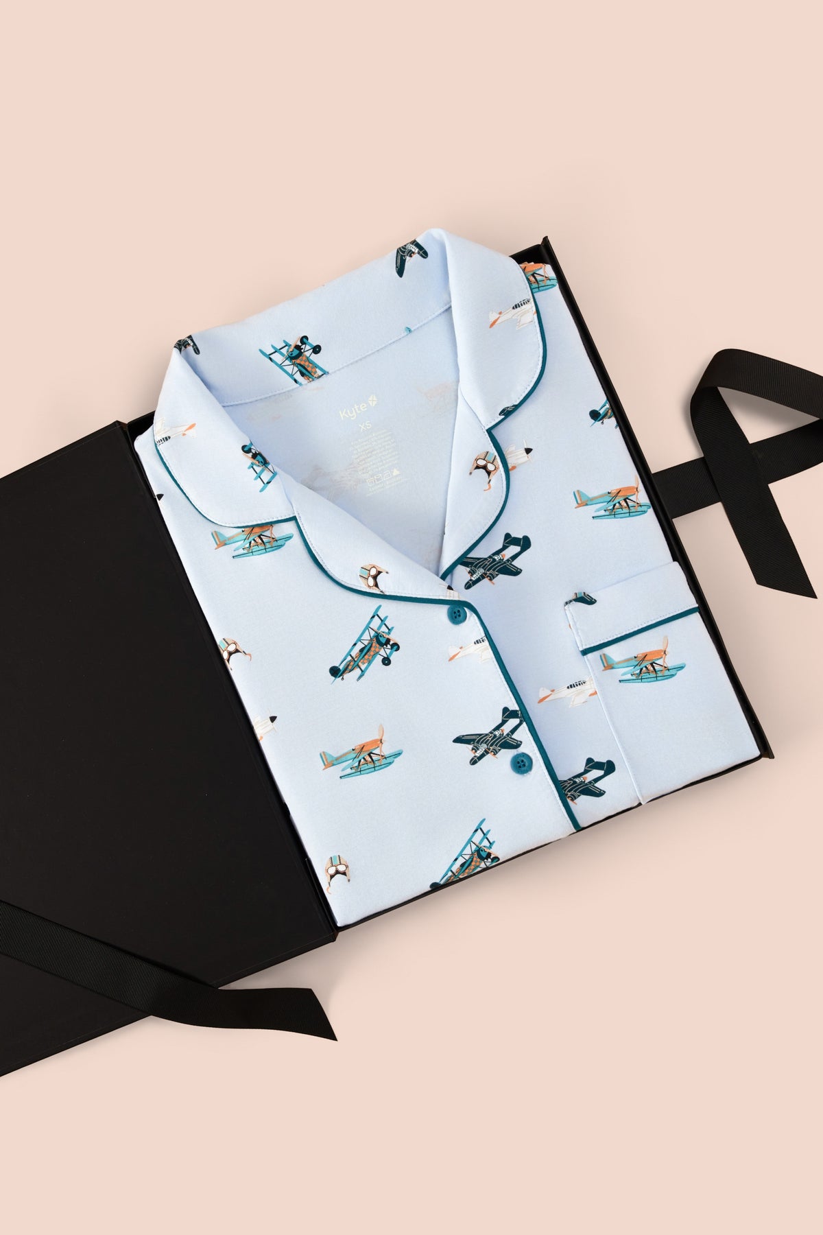 Women's Short Sleeve Pajama Set in Take Off print packed in a box on a beige background