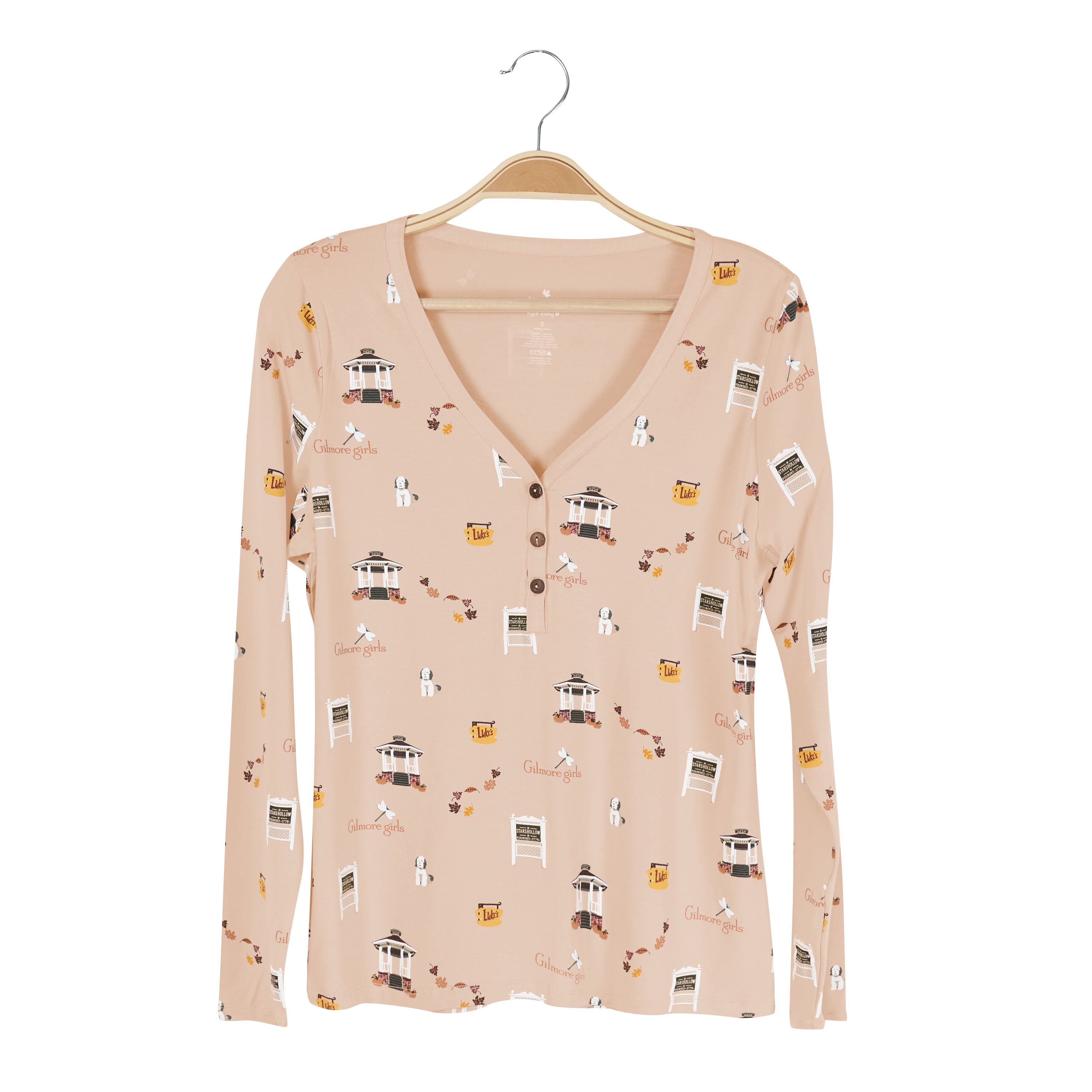 Long-sleeve women's shirt with a Gilmore Girls pattern on a hanger against a white background