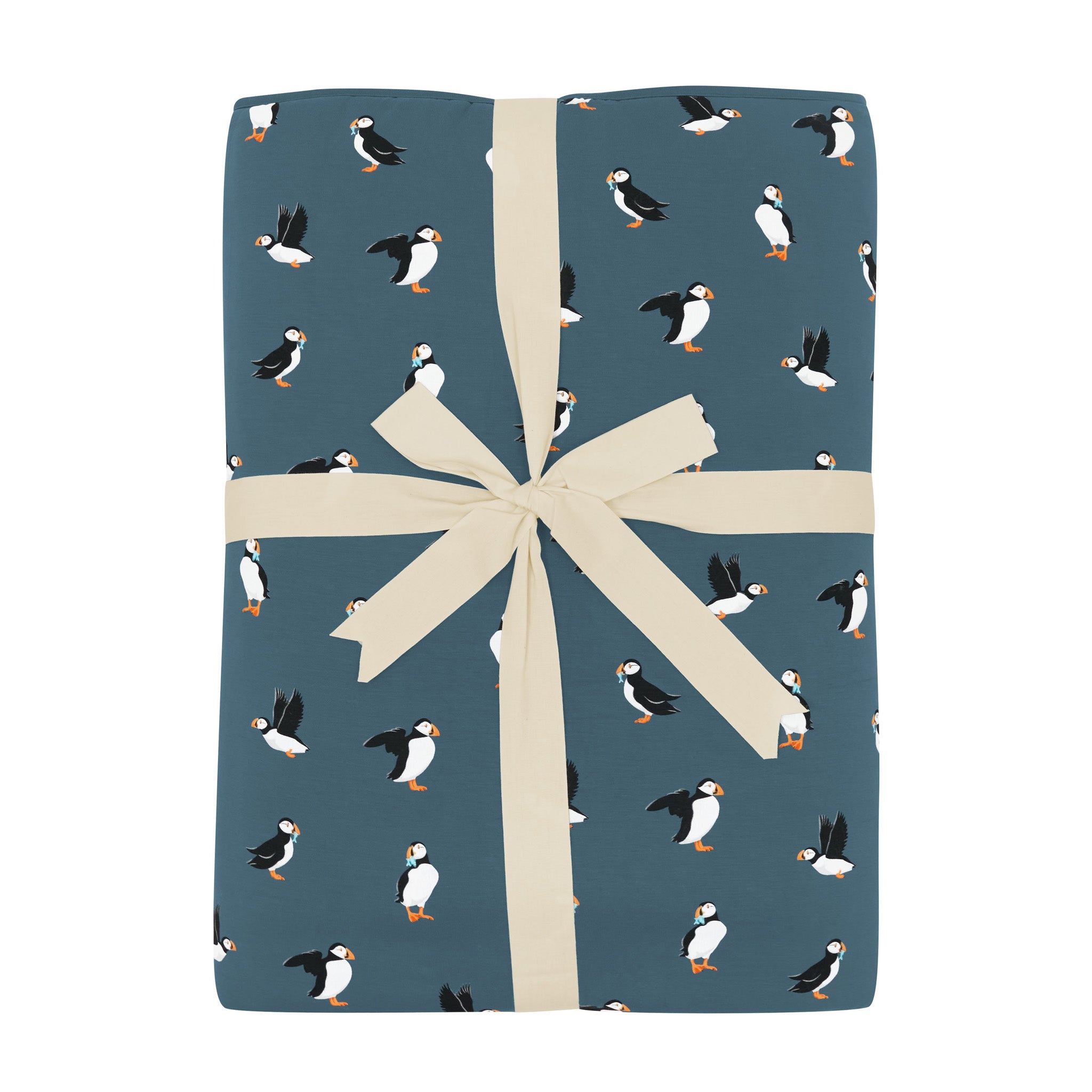 Youth Blanket in Puffin 2.5 shown in its packaging tied in a linen bow