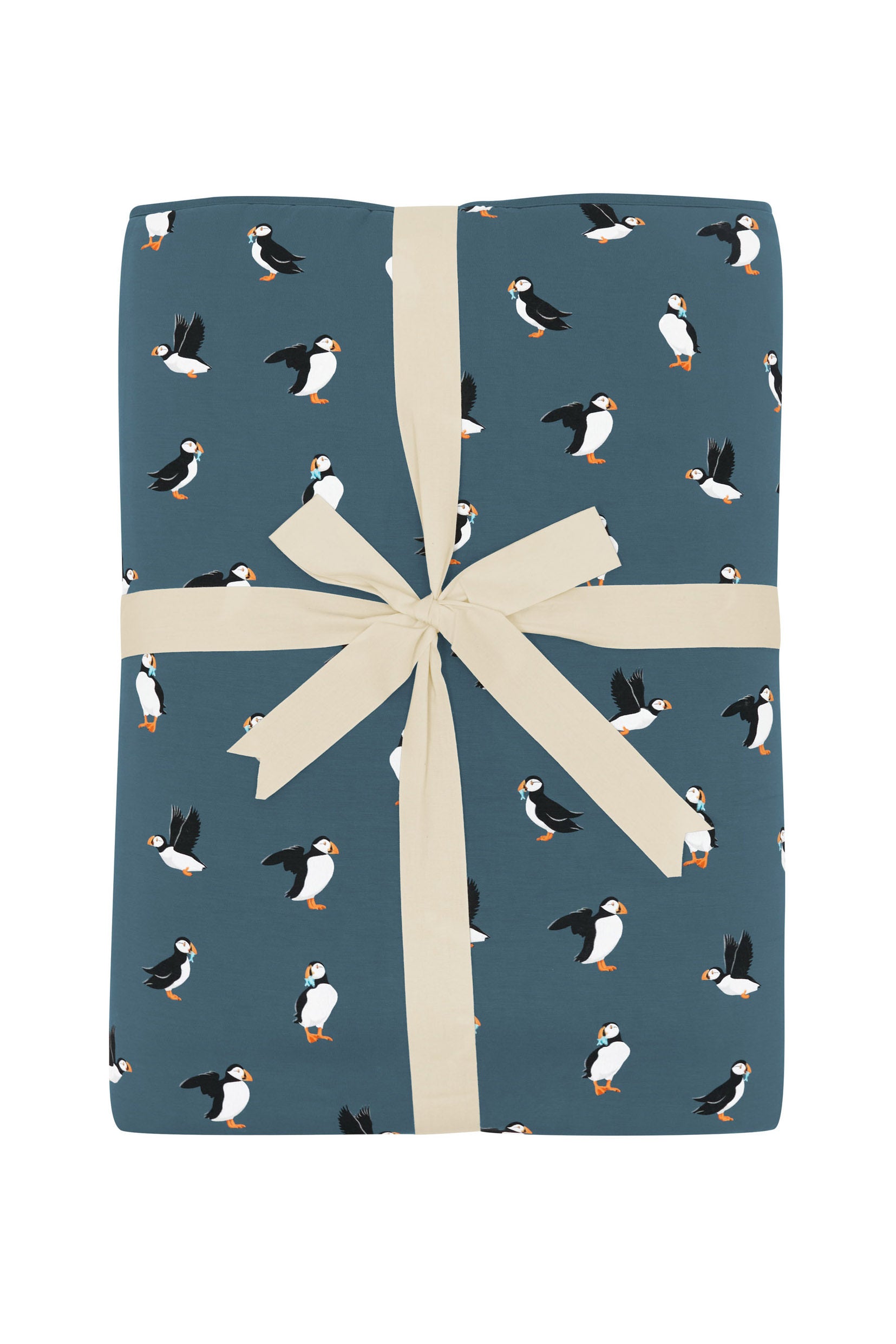 Youth Blanket in Puffin 2.5 shown in its packaging tied in a linen bow