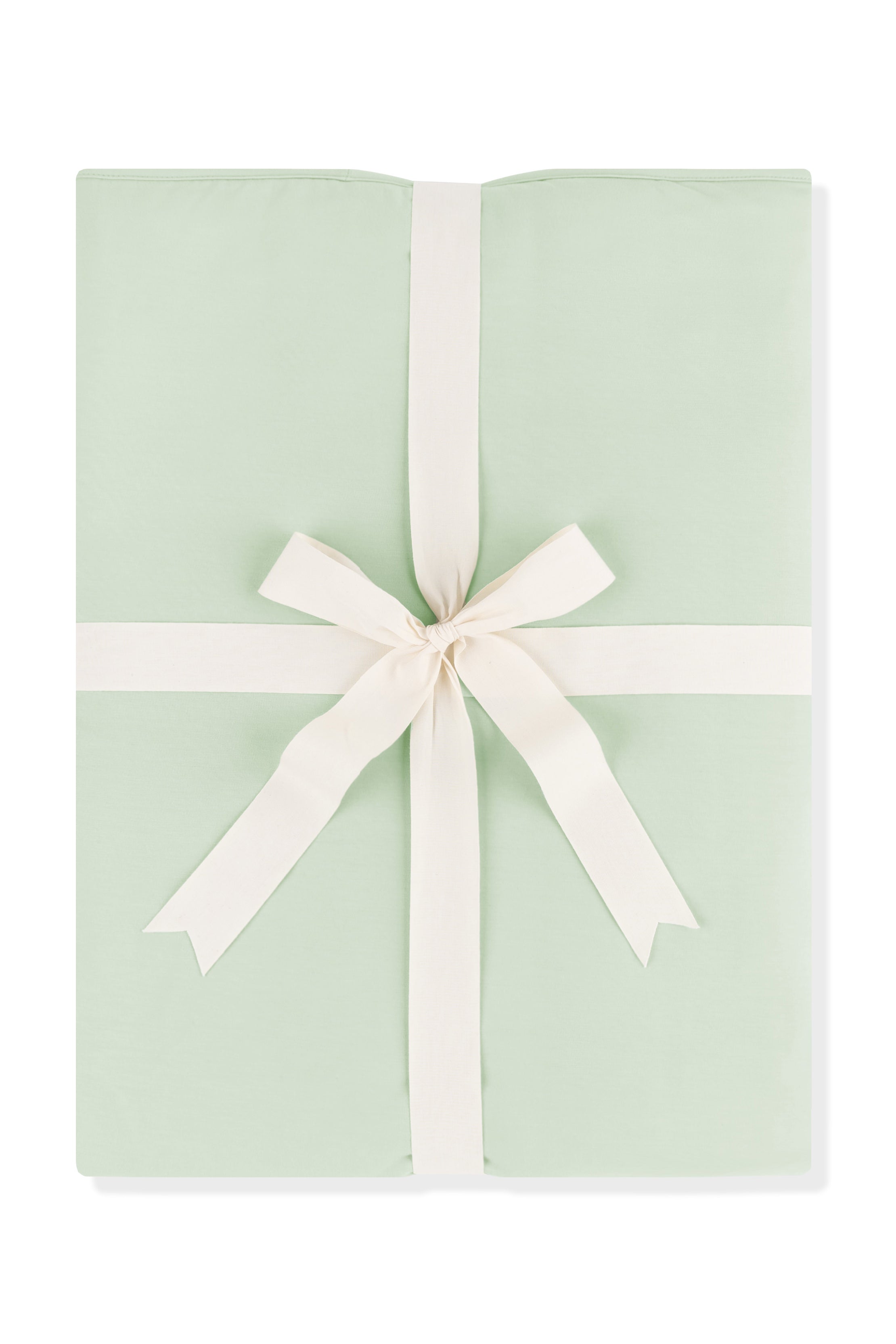 Youth Blanket in Basil 1.0 shown wrapped in its packaging tied with a linen bow