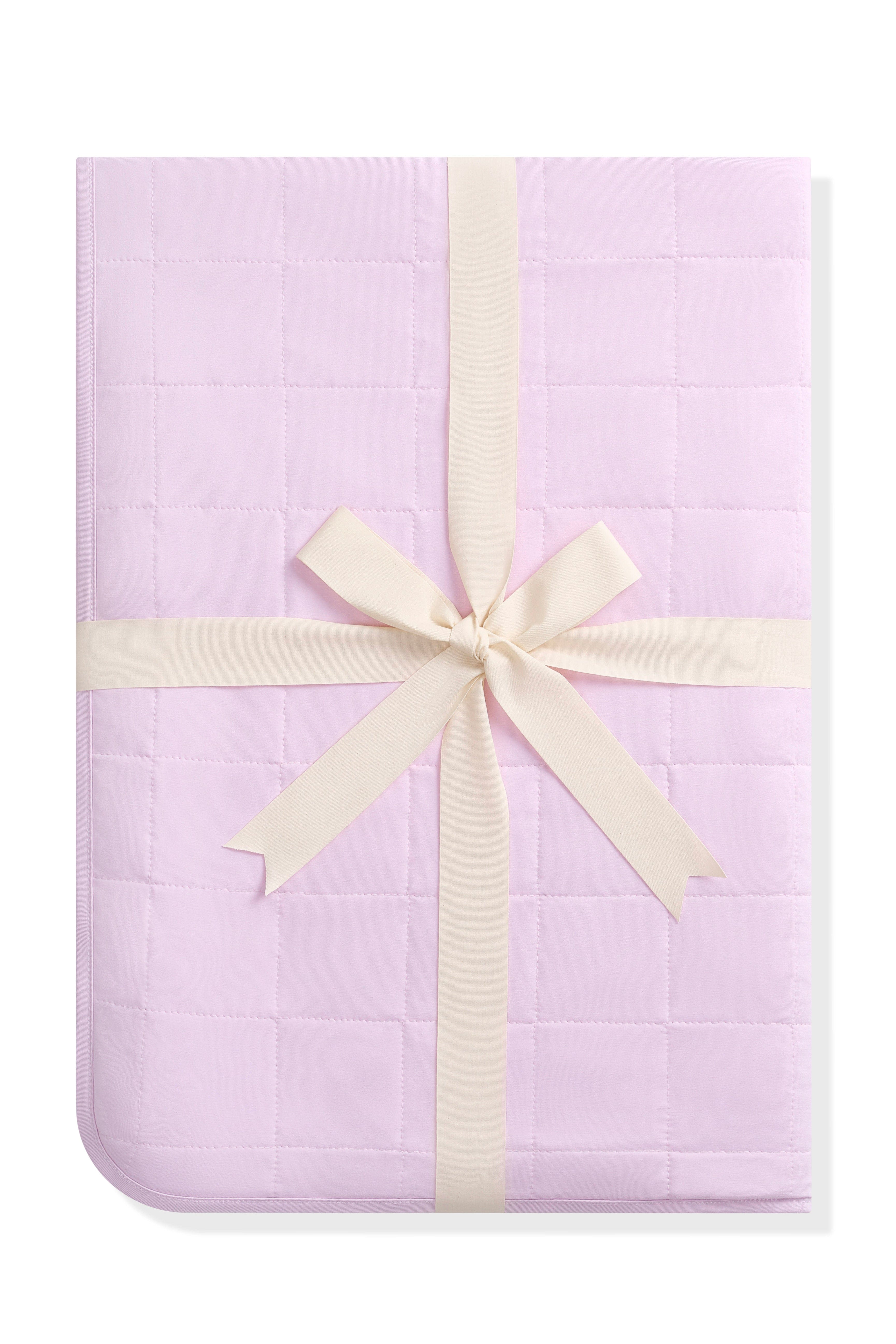 Youth Blanket in Thistle 1.0 shown in its packaging tied in a linen bow