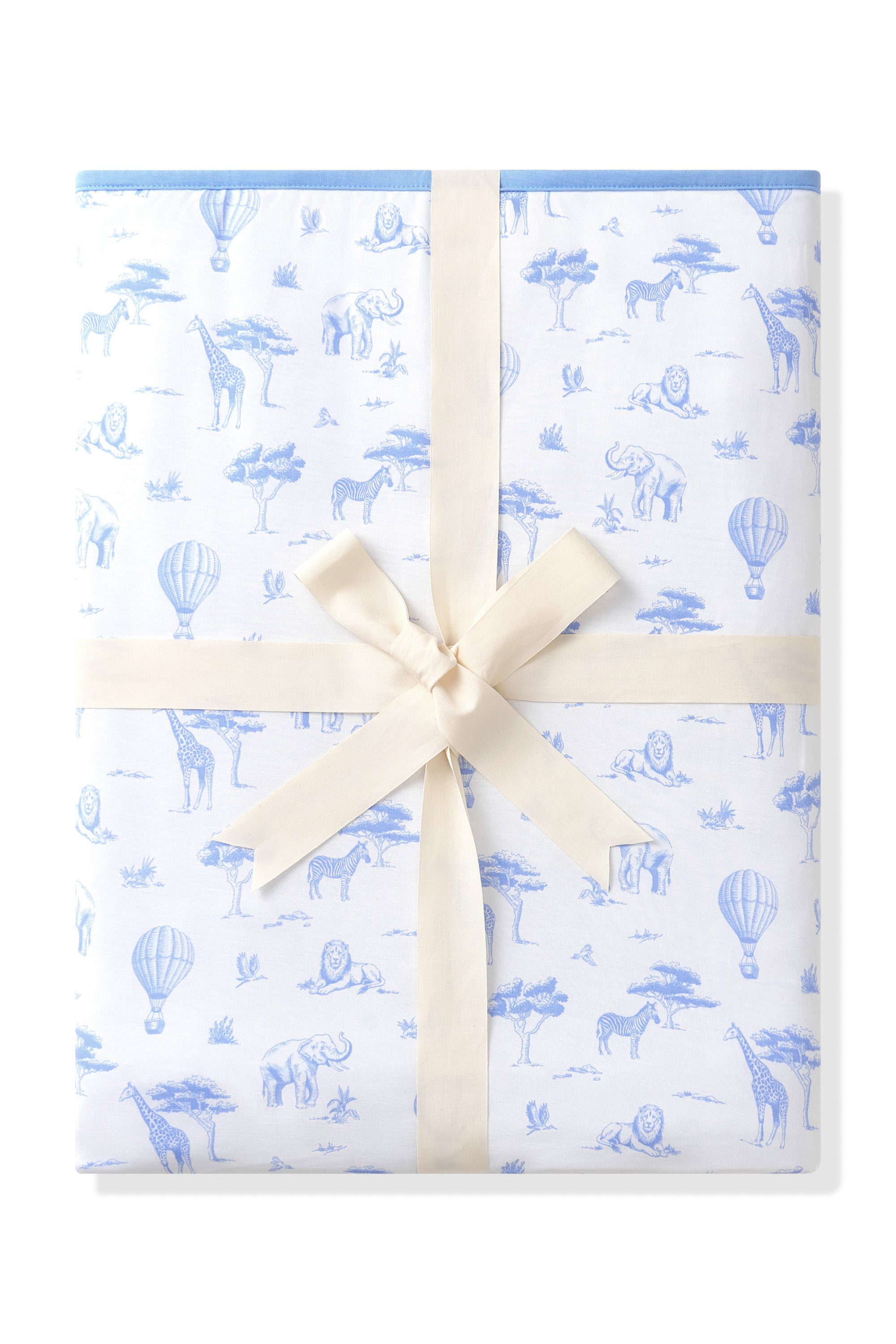 Youth Blanket in Toile Safari 1.0 shown tied up in a linen bow