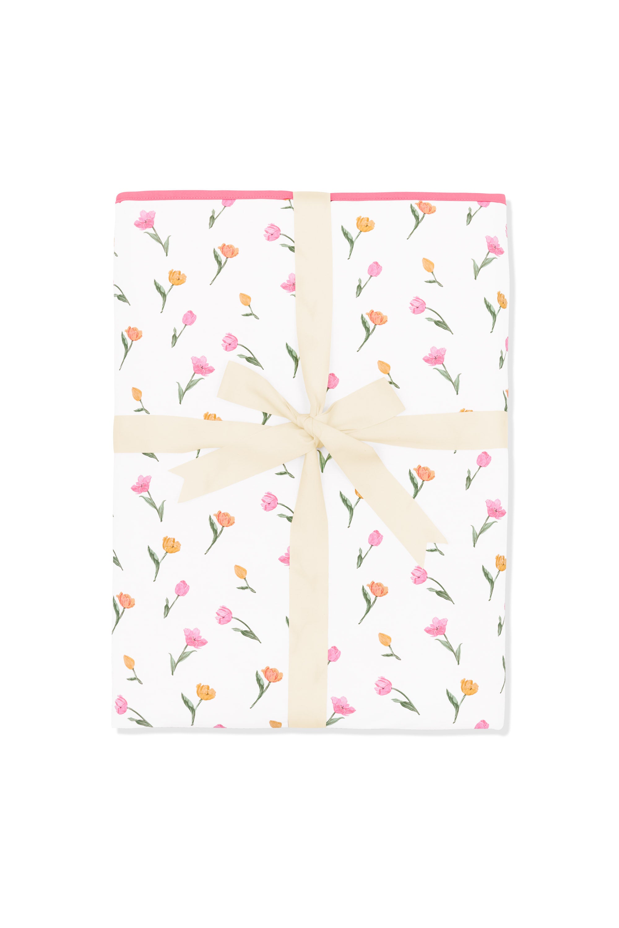 Youth Blanket in Tulip 1.0 shown in its packaging tied with a linen bow