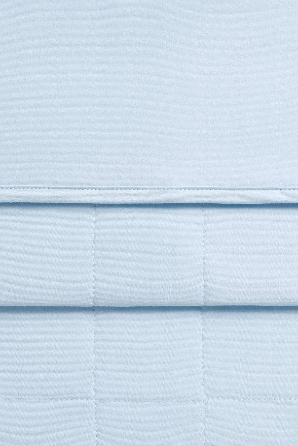 Close up of the Youth Blanket in Breeze 1.0 showing the quilted backing and smooth top layer