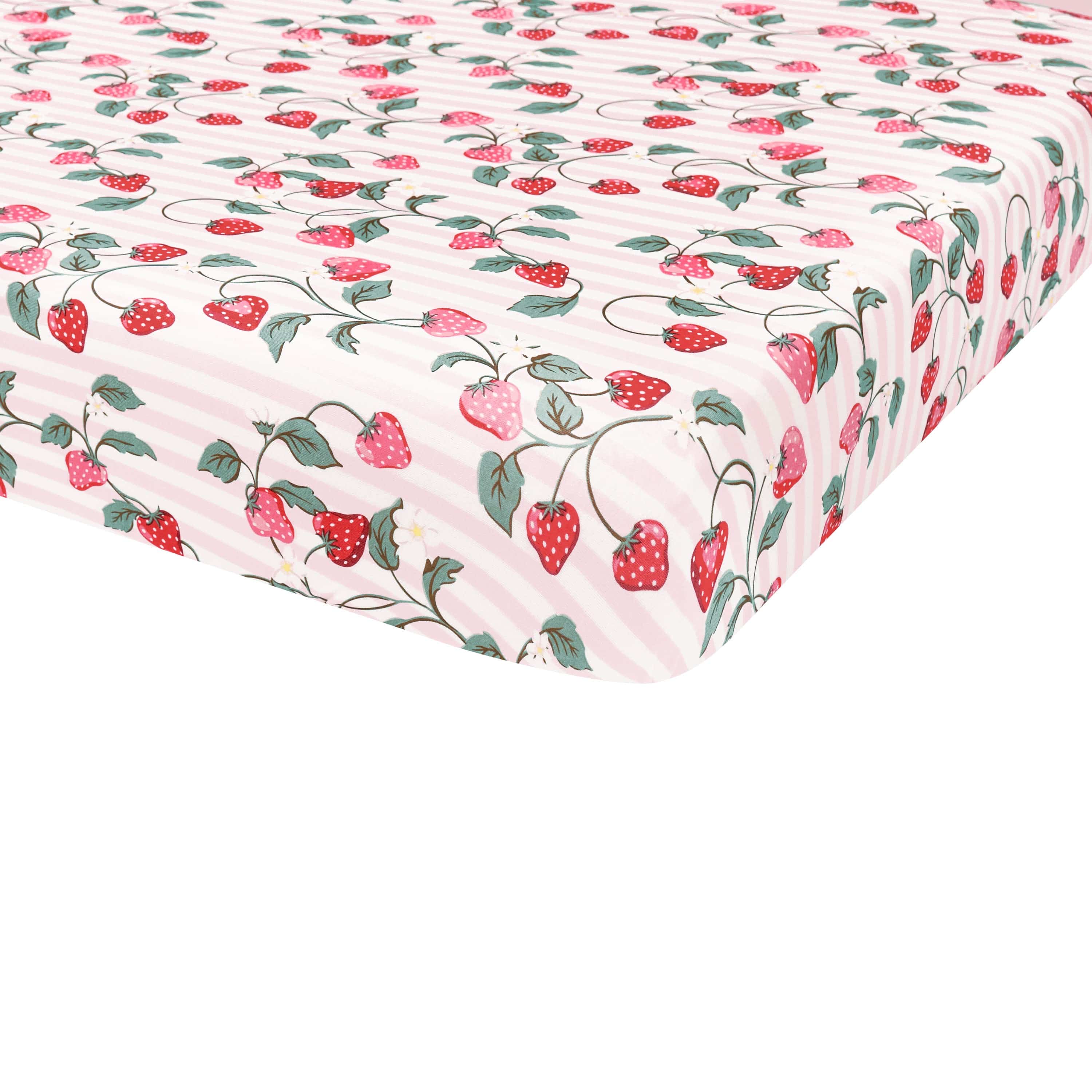 Corner of the Crib Sheet in Strawberry Fields shown on a crib mattress