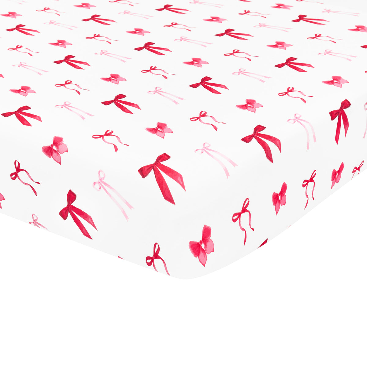 The soft and breathable Crib Sheet in Small Love Bow shown on a crib mattress