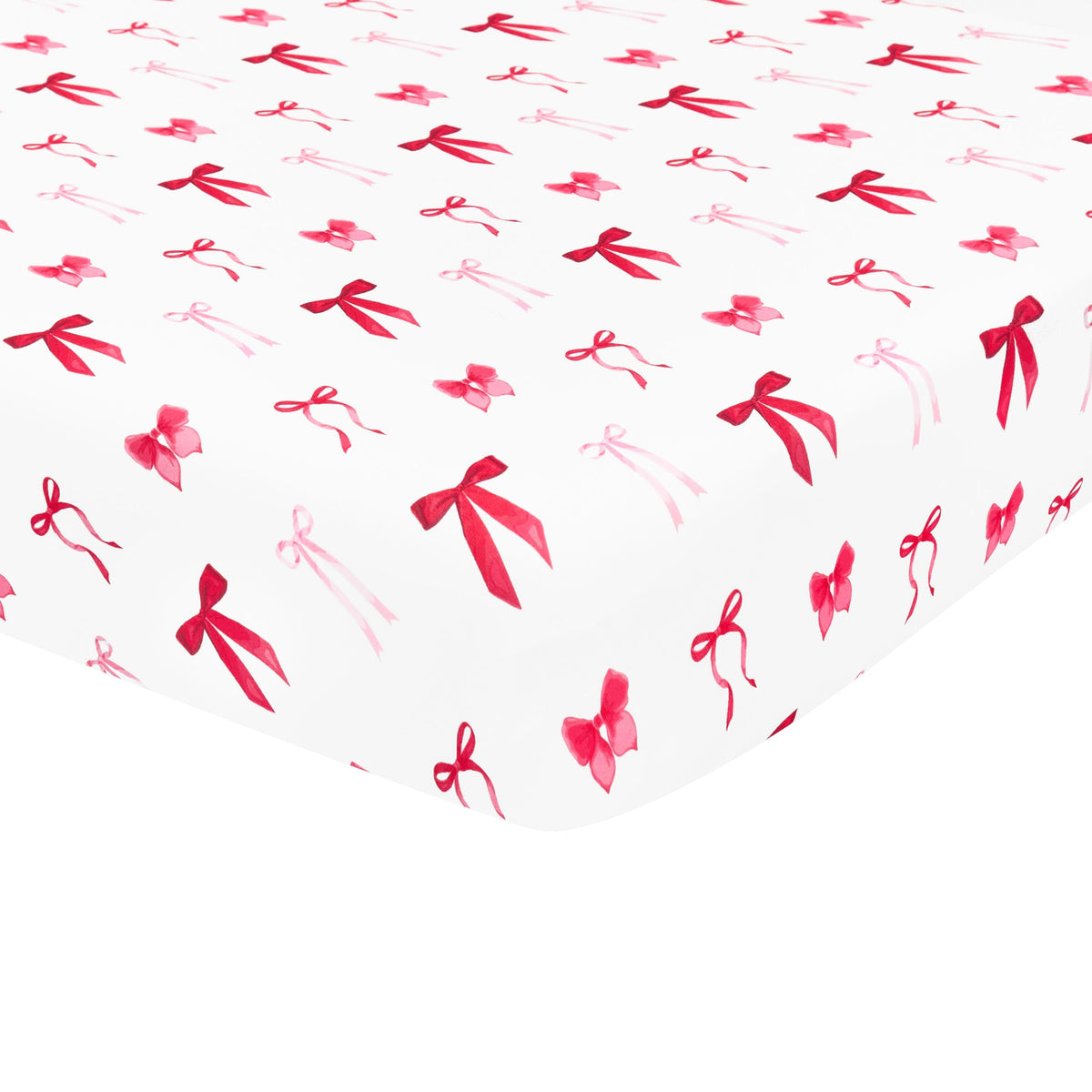 The soft and breathable Crib Sheet in Small Love Bow shown on a crib mattress