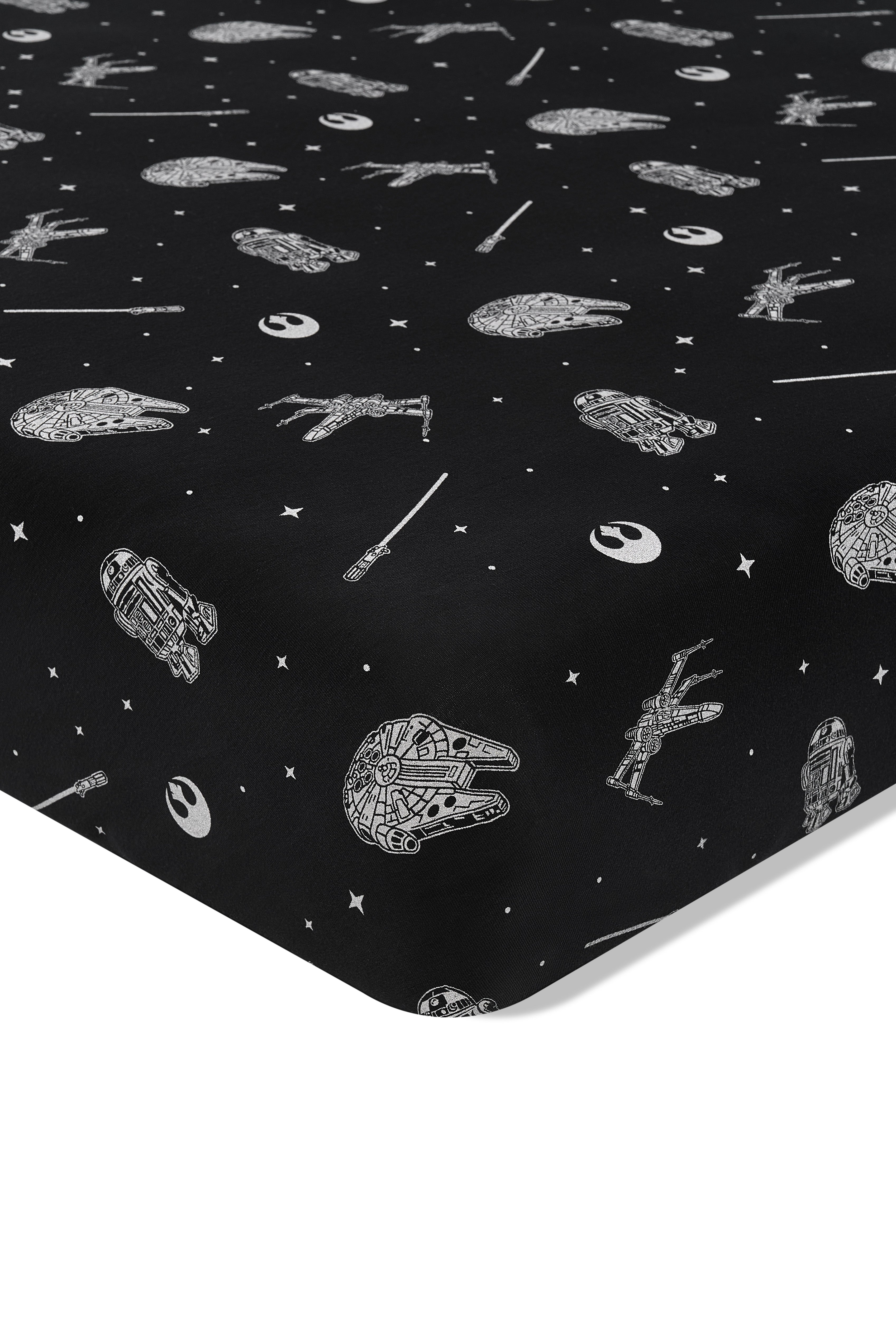 Close up of the corner of the Crib Sheet in STAR WARS™ on a crib mattress