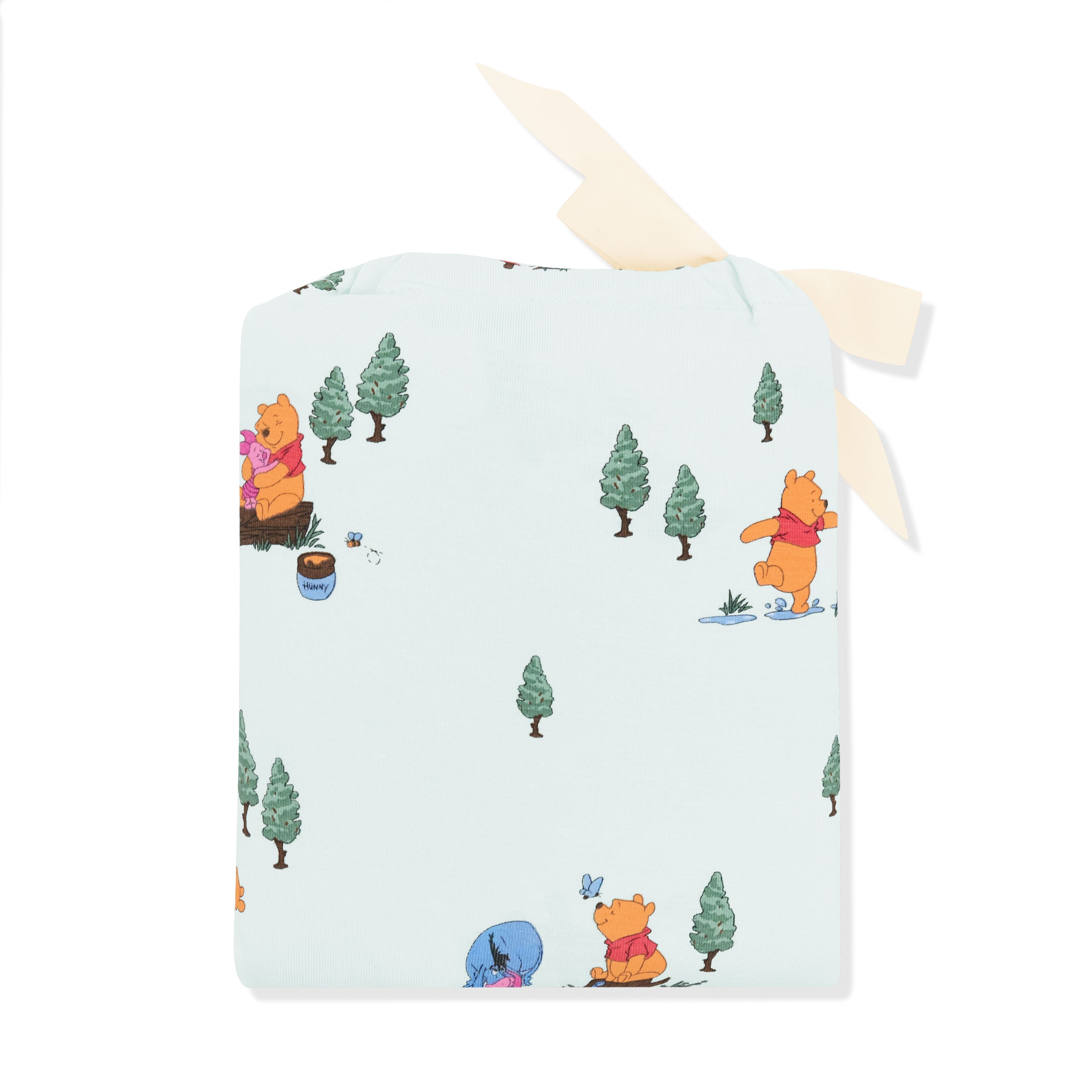 Crib Sheet in Winnie the Pooh Hundred Acre Wood shown in its packaging