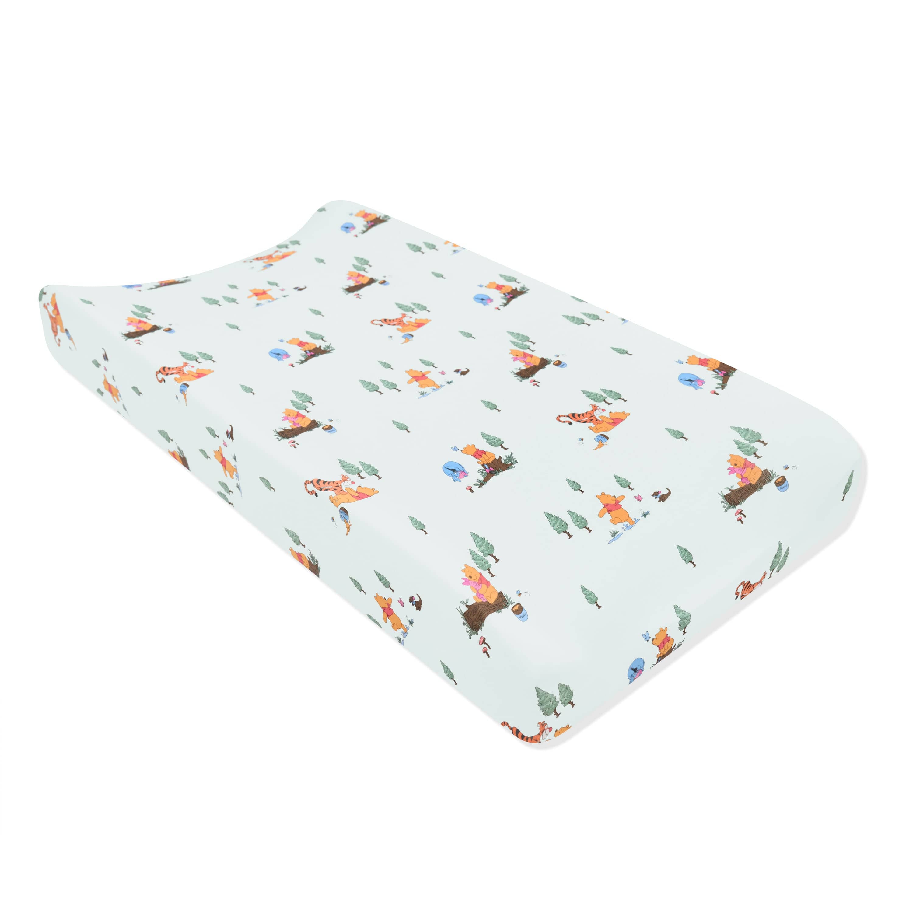 The Change Pad Cover in Winnie the Pooh Hundred Acre Wood shown on a change pad