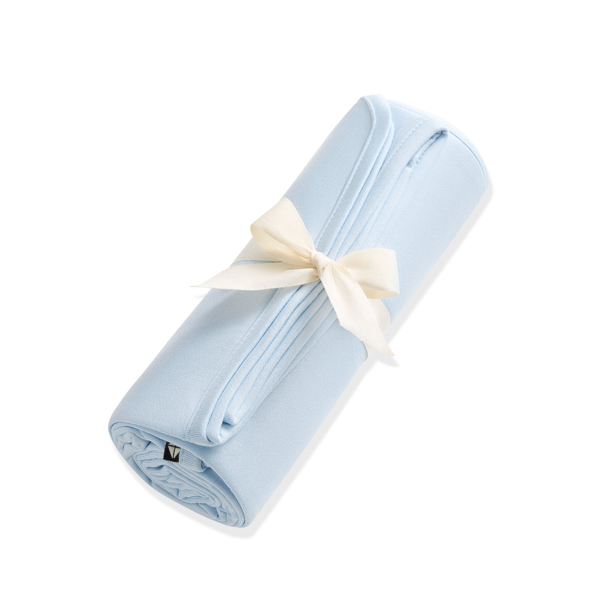 Swaddle Blanket in Breeze shown rolled in its packaging tied with a linen bow
