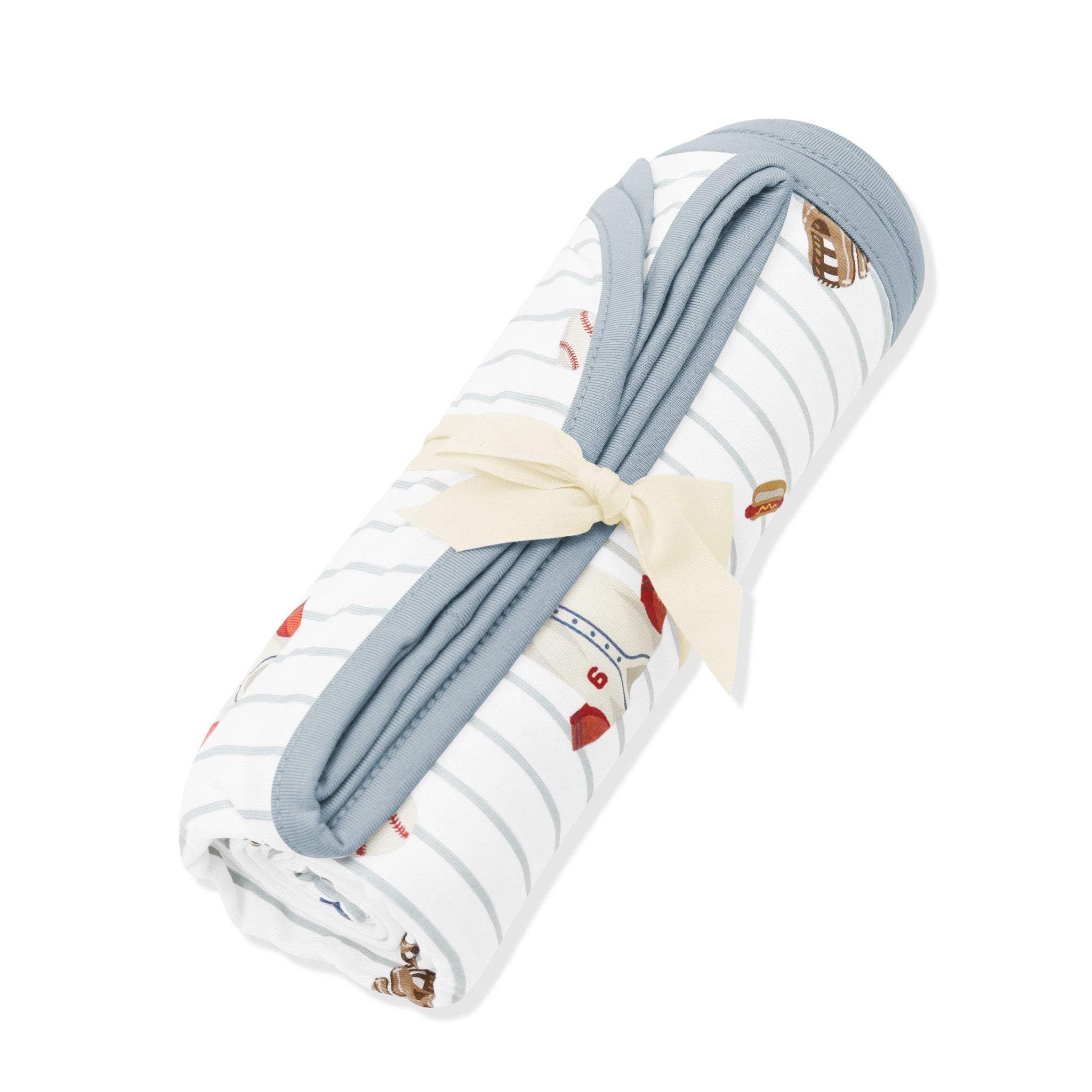 Swaddle Blanket in Home Run shown rolled in its packaging tied with a linen bow