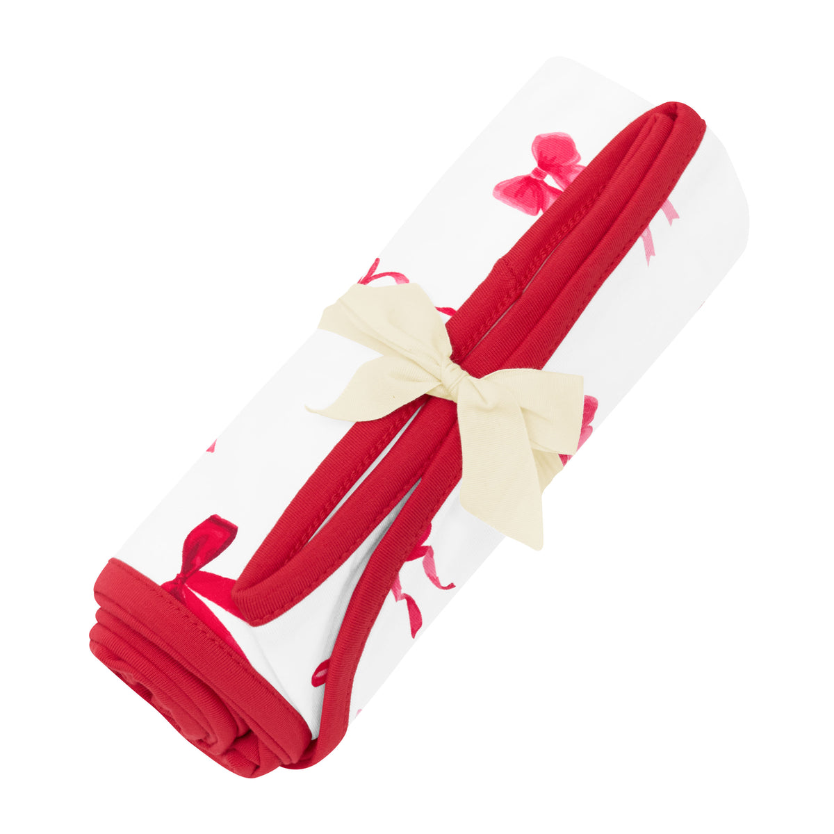 Swaddle Blanket in Small Love Bow shown rolled in its packaging tied with a linen bow