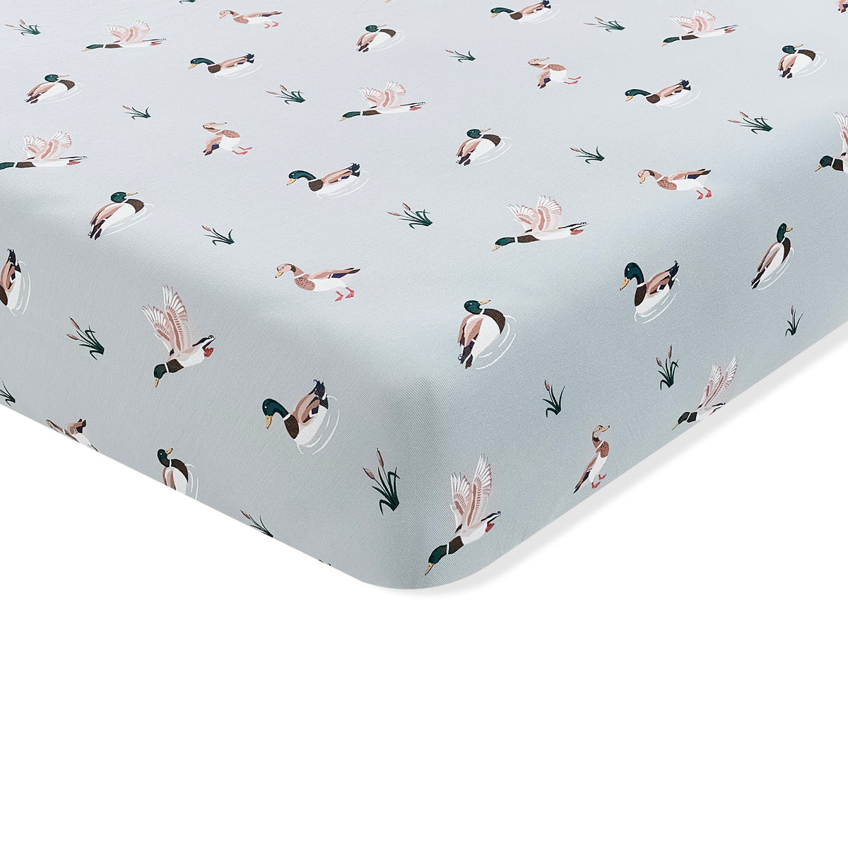 The corner of the Twin Sheet in Mallard Duck shown on a mattress