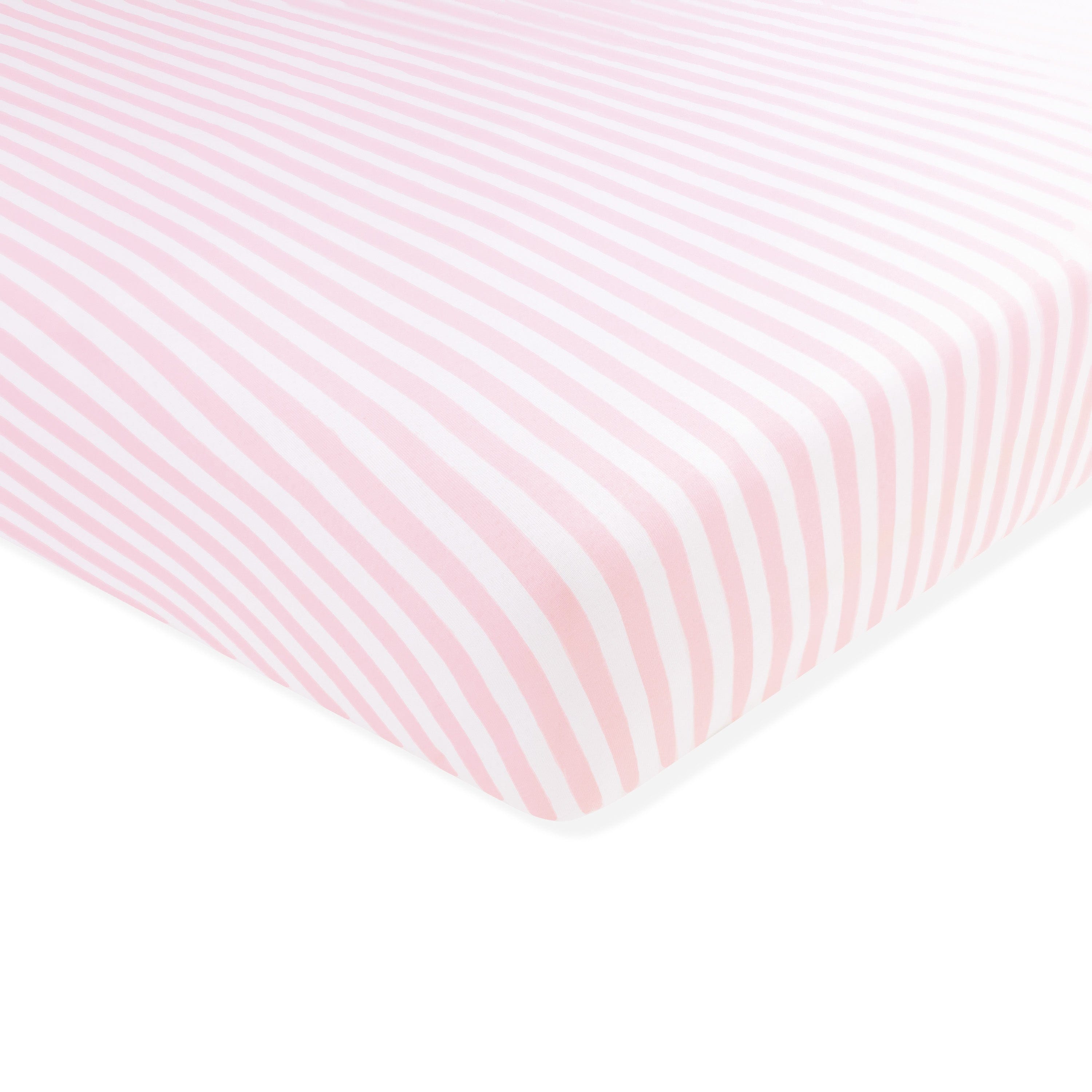 Corner of the Twin Sheet in Small Sakura Stripe shown on a crib mattress
