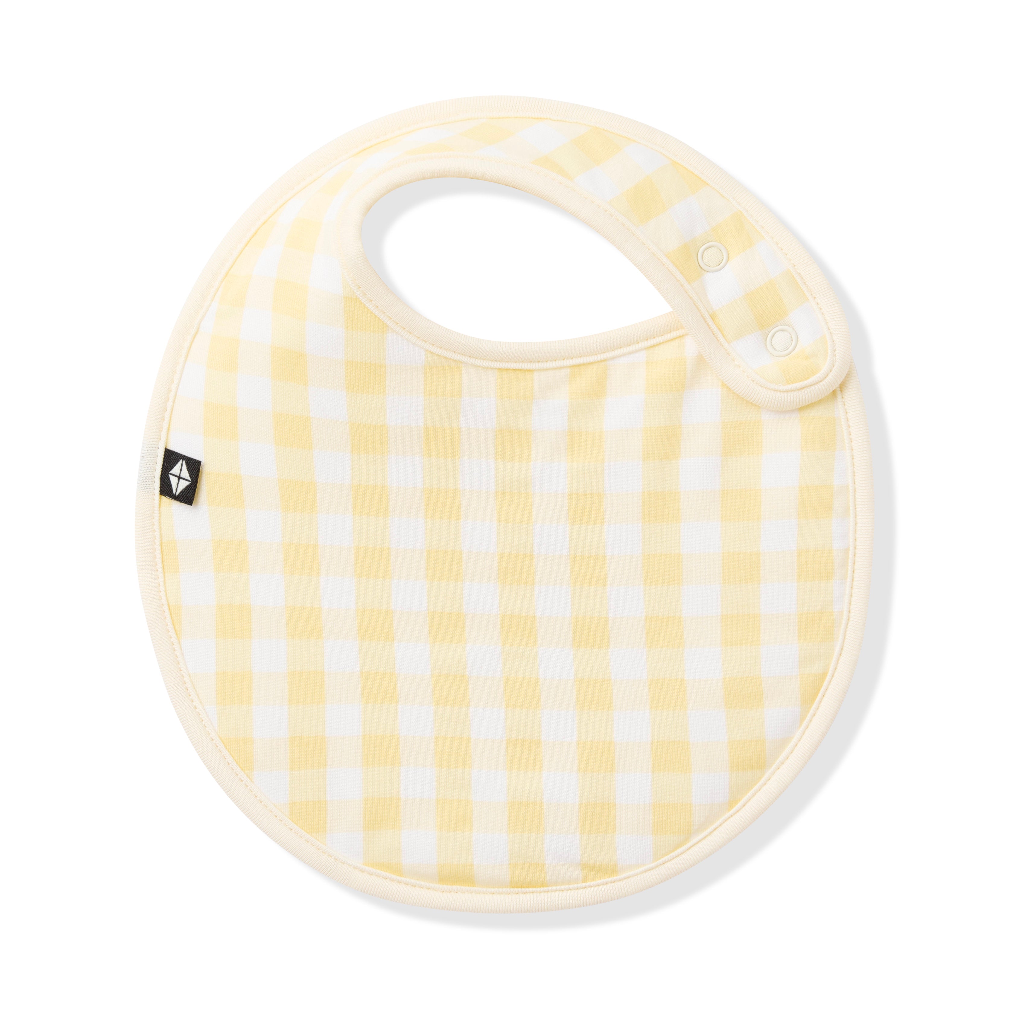 Front of the Cushy Bib in Gingham Chamomile with the snap closures visible