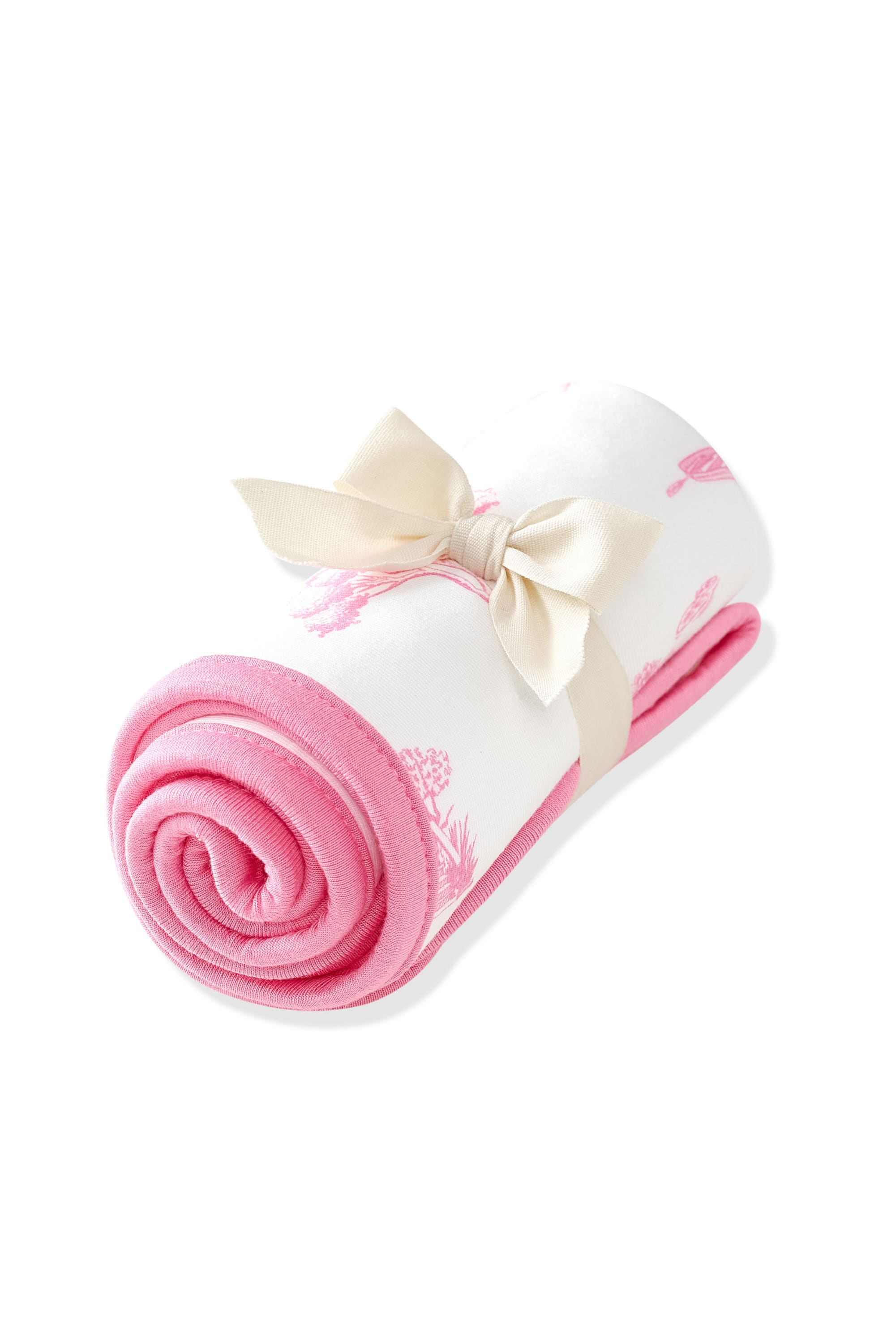 Burp Cloth in Toile Ballet shown rolled in its packaging tied with a linen bow
