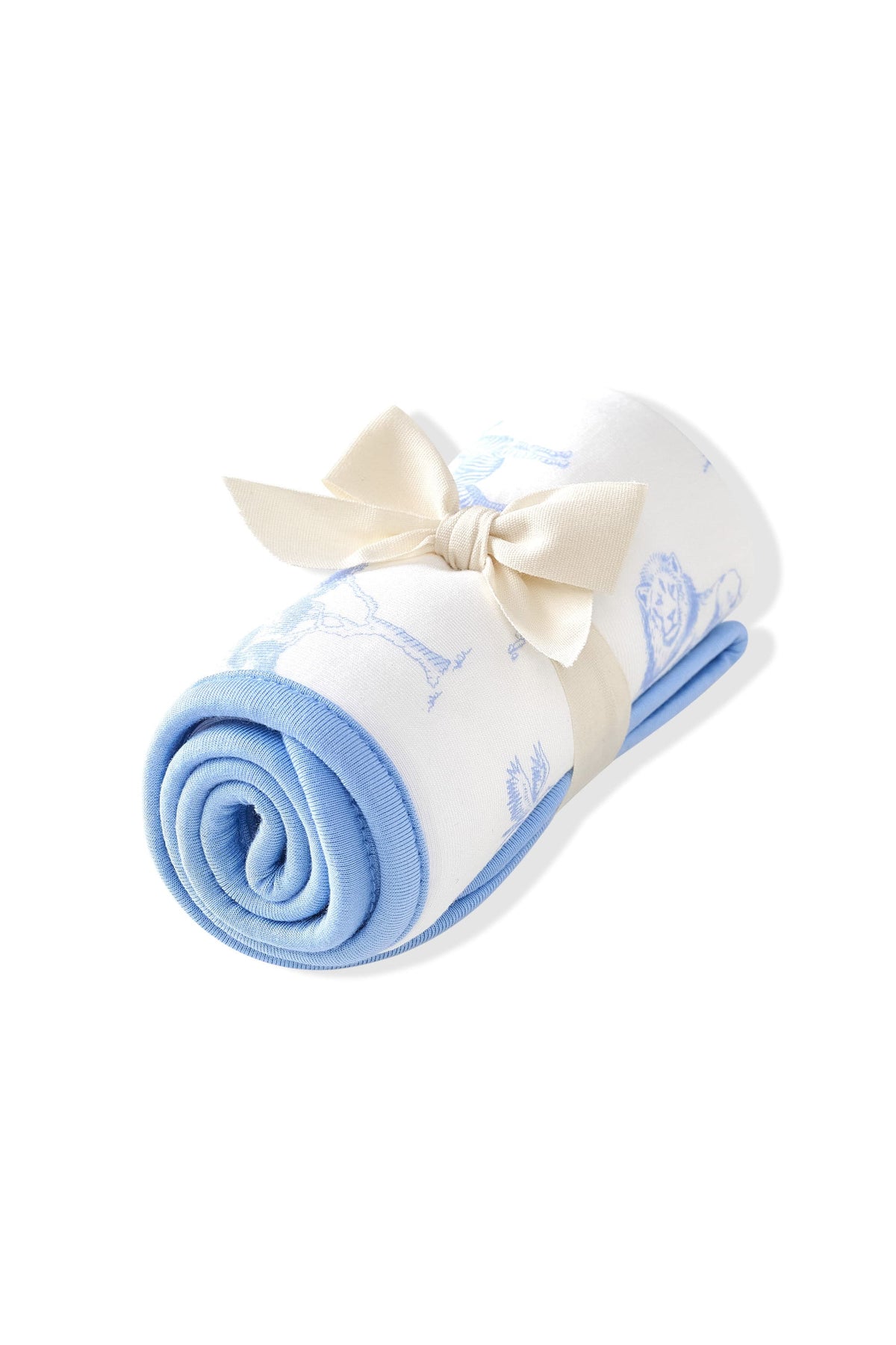 Burp Cloth in Toile Safari shown rolled in its packaging tied with a linen bow