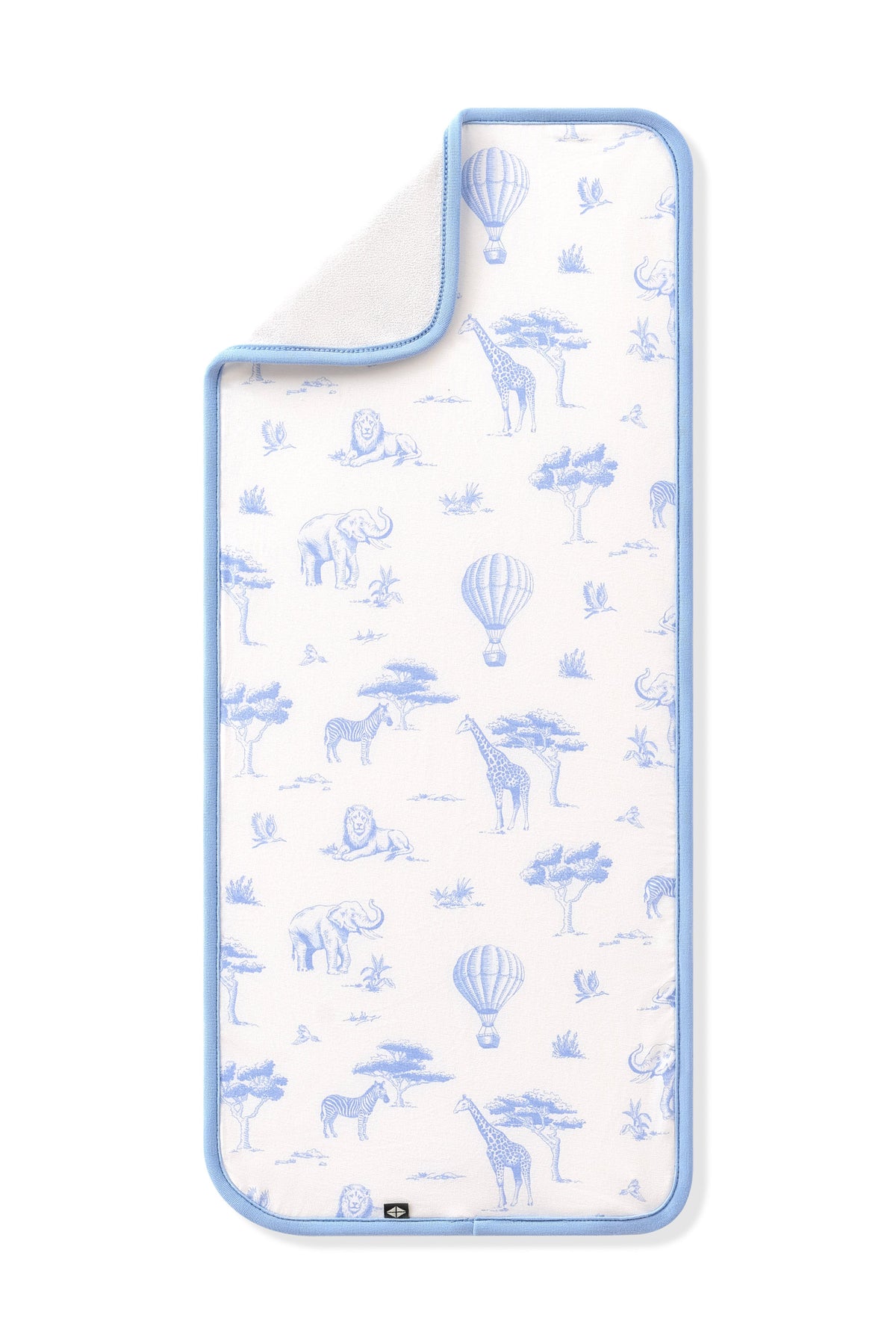 The Burp Cloth in Toile Safari shown laid flat with the corner folded down showing the absorbent bamboo terry backing