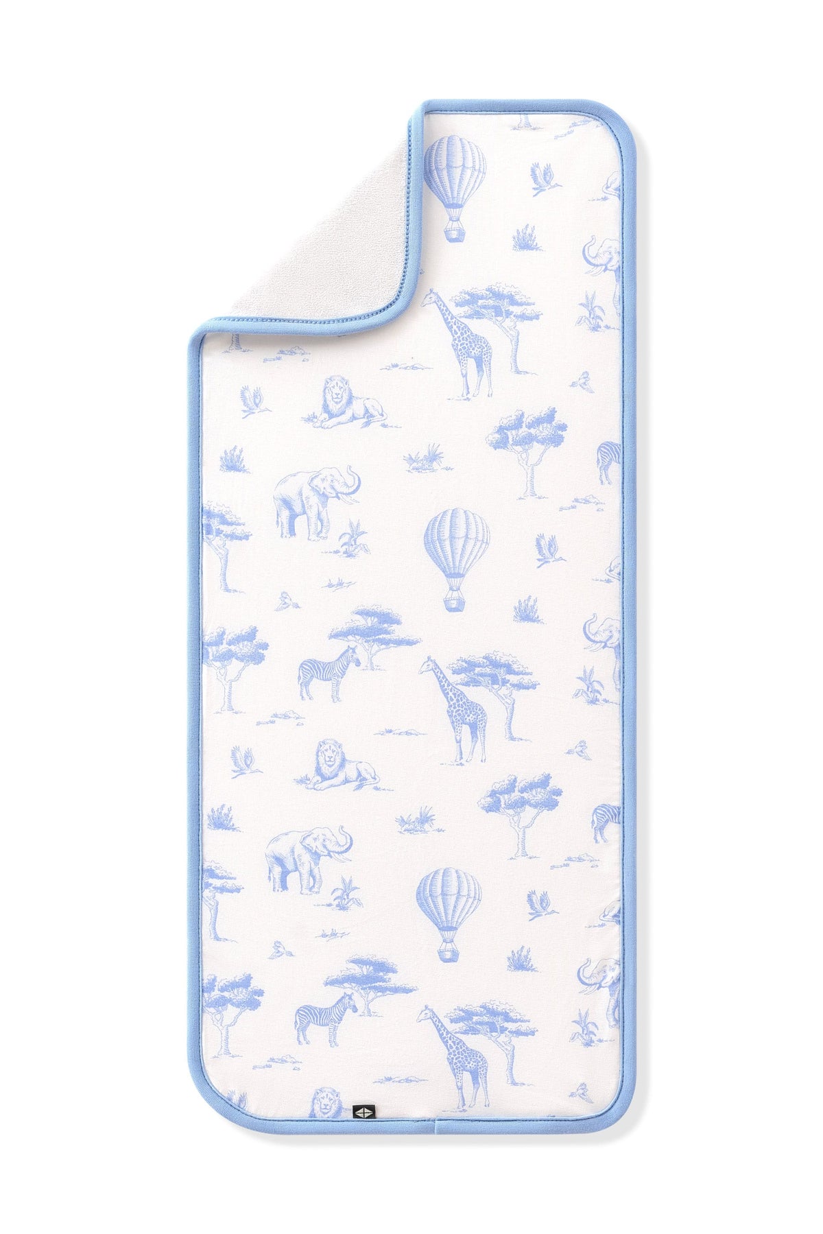 The Burp Cloth in Toile Safari shown laid flat with the corner folded down showing the absorbent bamboo terry backing