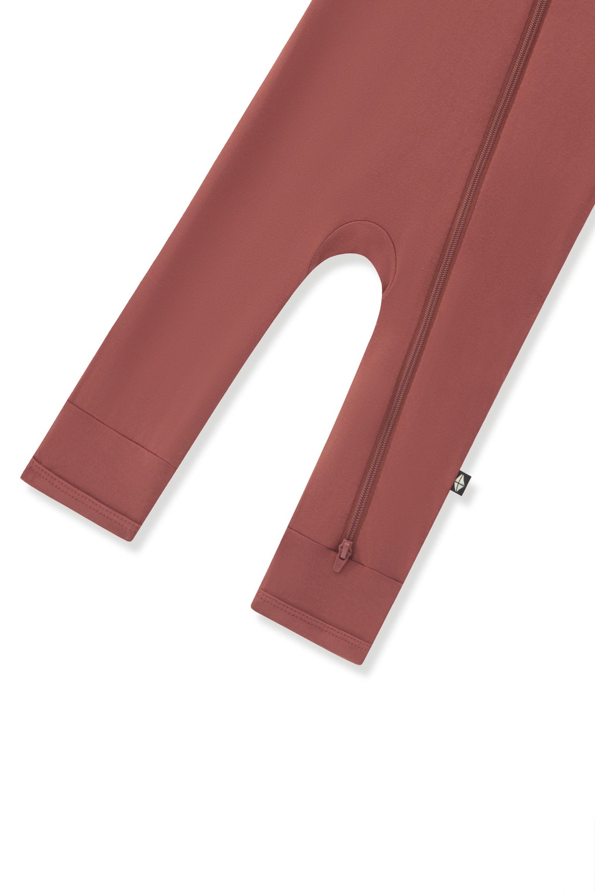 Bottom zipper shown on the leg of the Zippered Romper in Ember on a white background