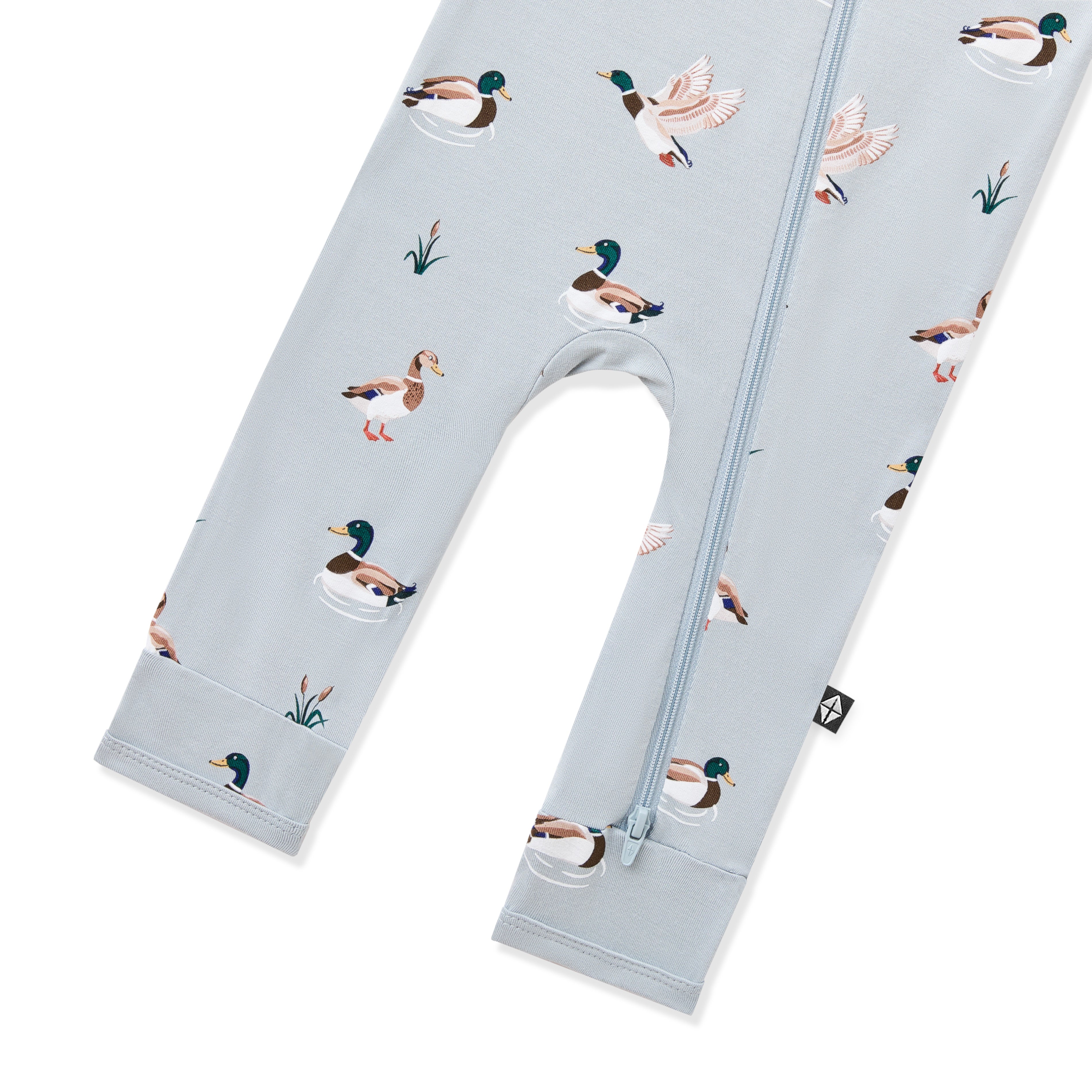 Close up of the zipper closure shown on the leg of the Zippered Romper in Mallard Duck
