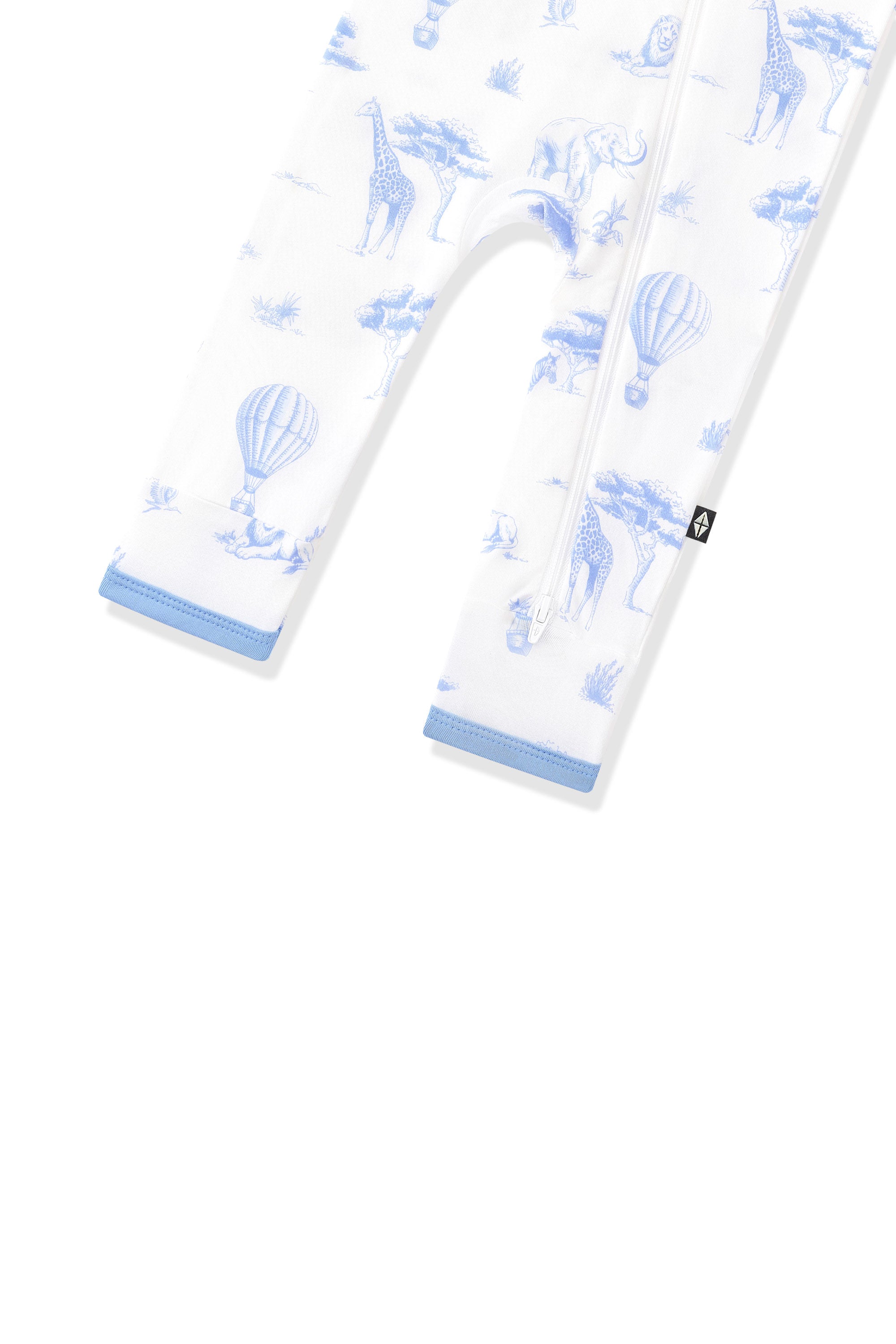 The zipper closure shown on the leg of the Zippered Romper in Toile Safari with the black kyte baby tag visible