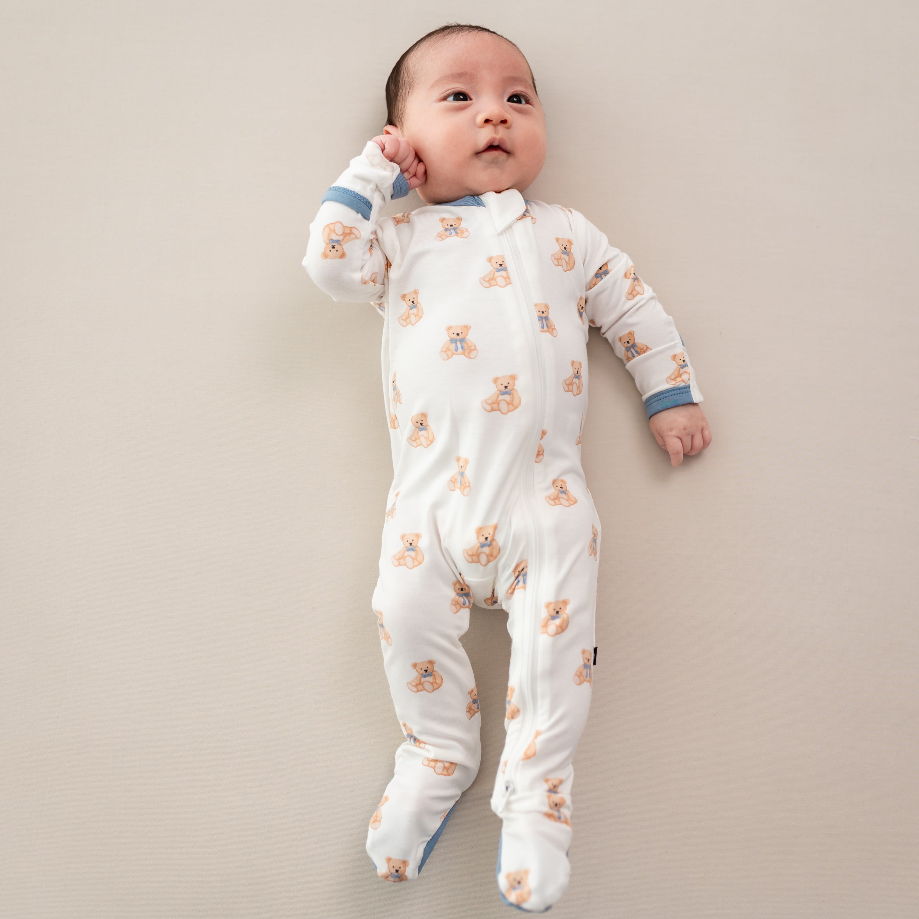 Infant wearing Zippered Footie bamboo pajamas in Teddy Bear
