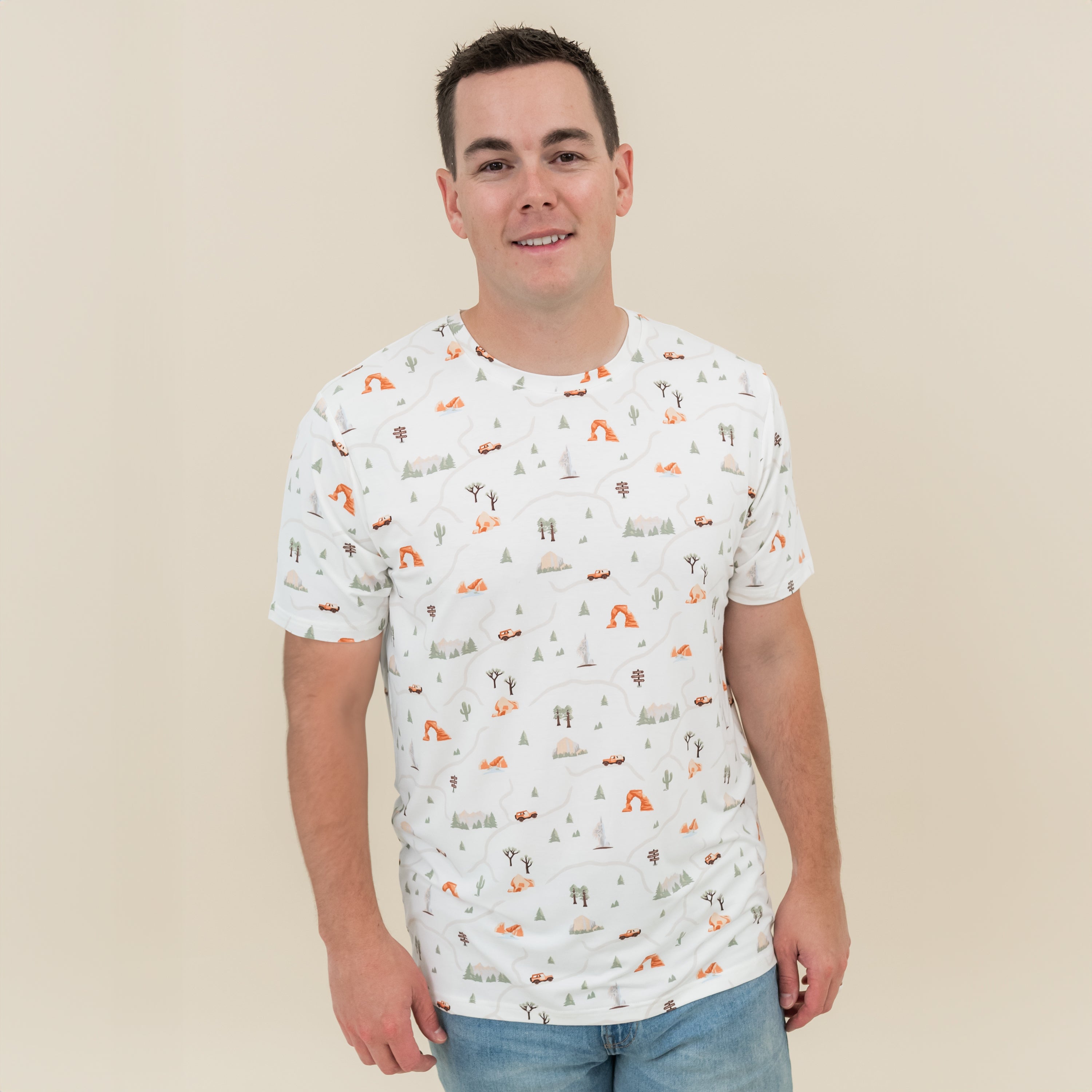 Male model wearing the Men's Crew Neck Tee in Road Trip with jeans