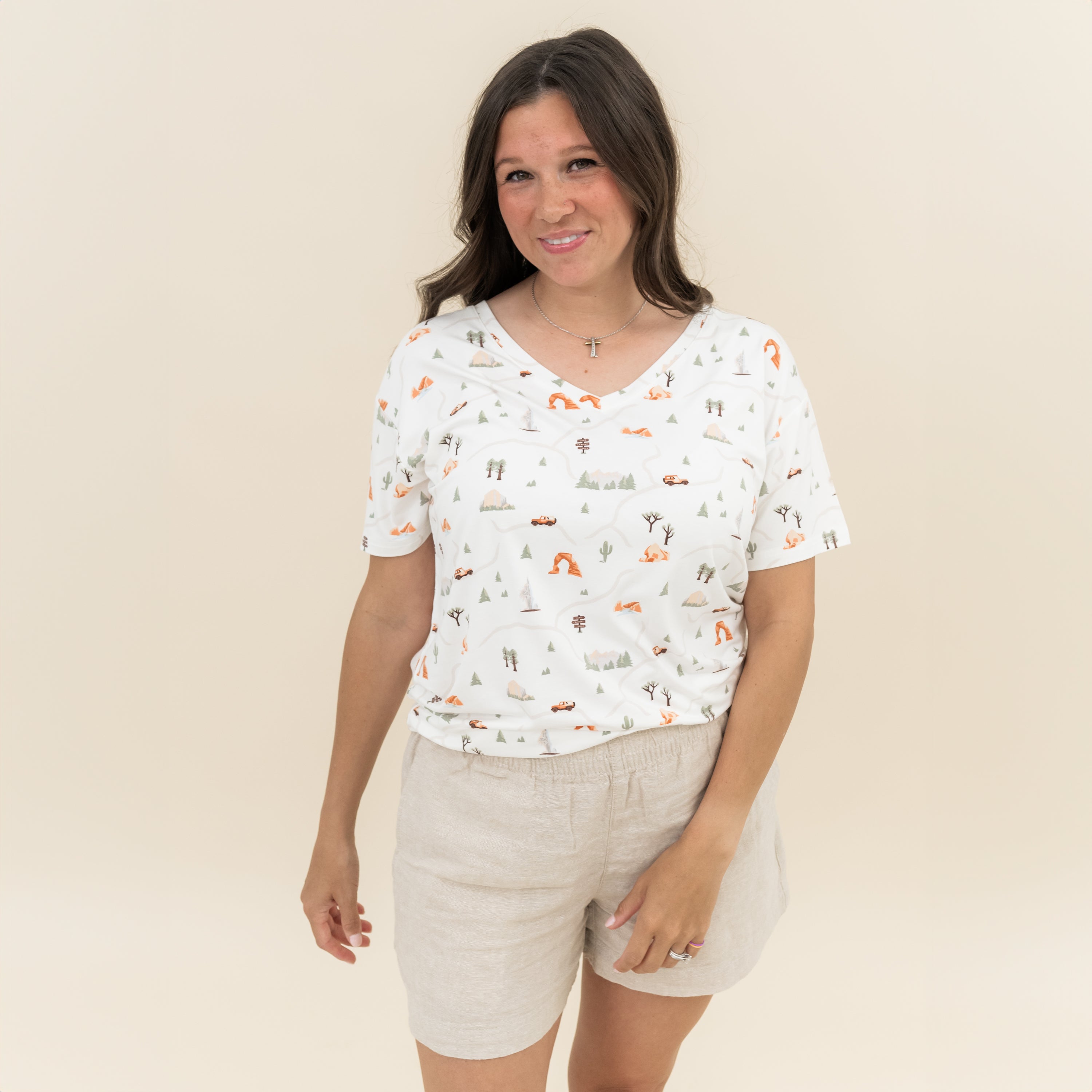 Female model wearing the Women's Relaxed Fit V-Neck in Road Trip with linen shorts