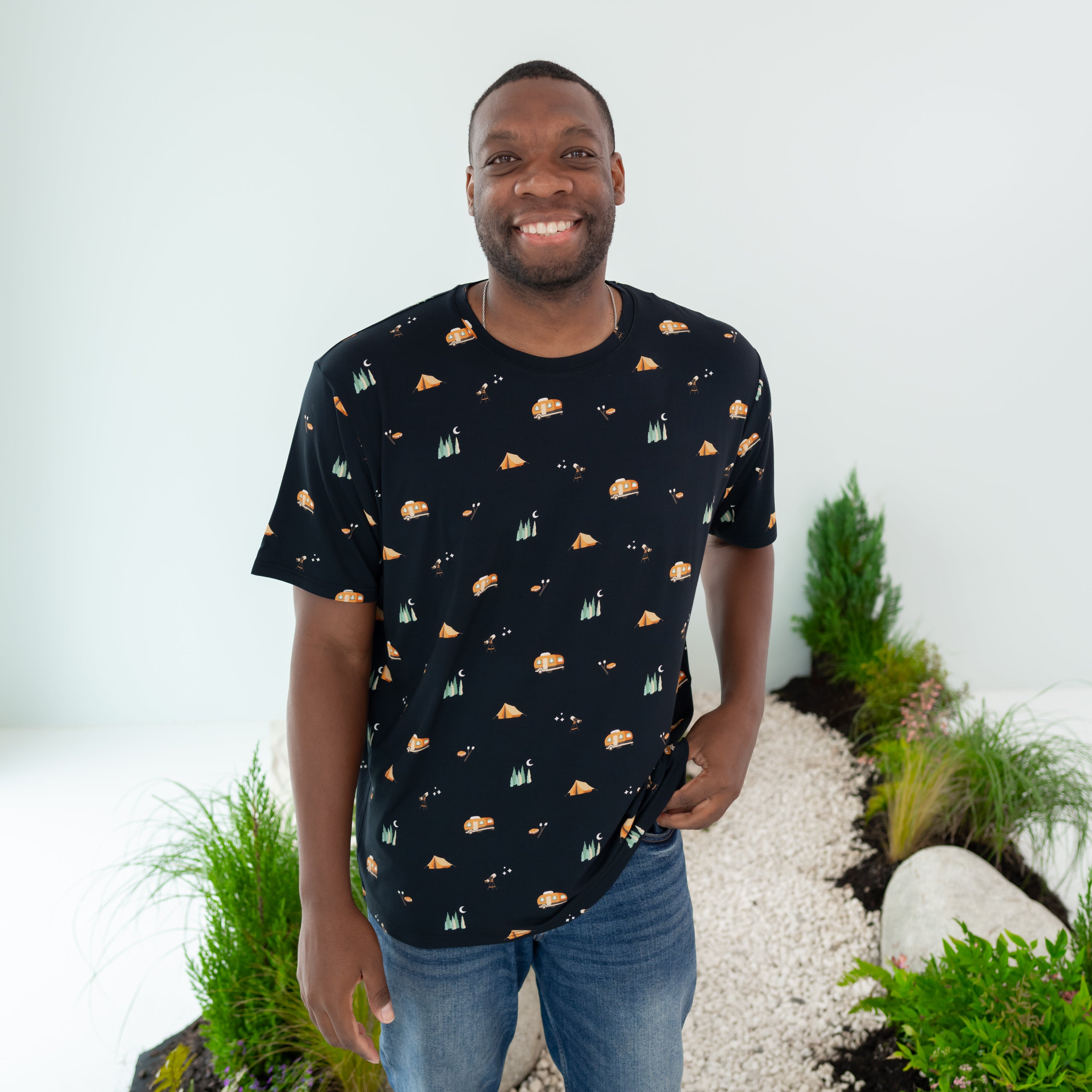 Male model wearing the Men's Crew Neck Tee in Under the Stars paired with jeans with one hand at his waist