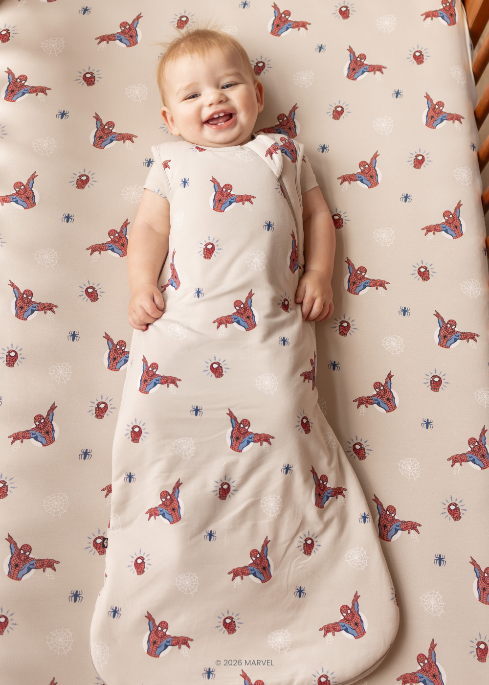 Baby in MARVEL spider-man sleep sack in a crib with matching super hero crib sheet