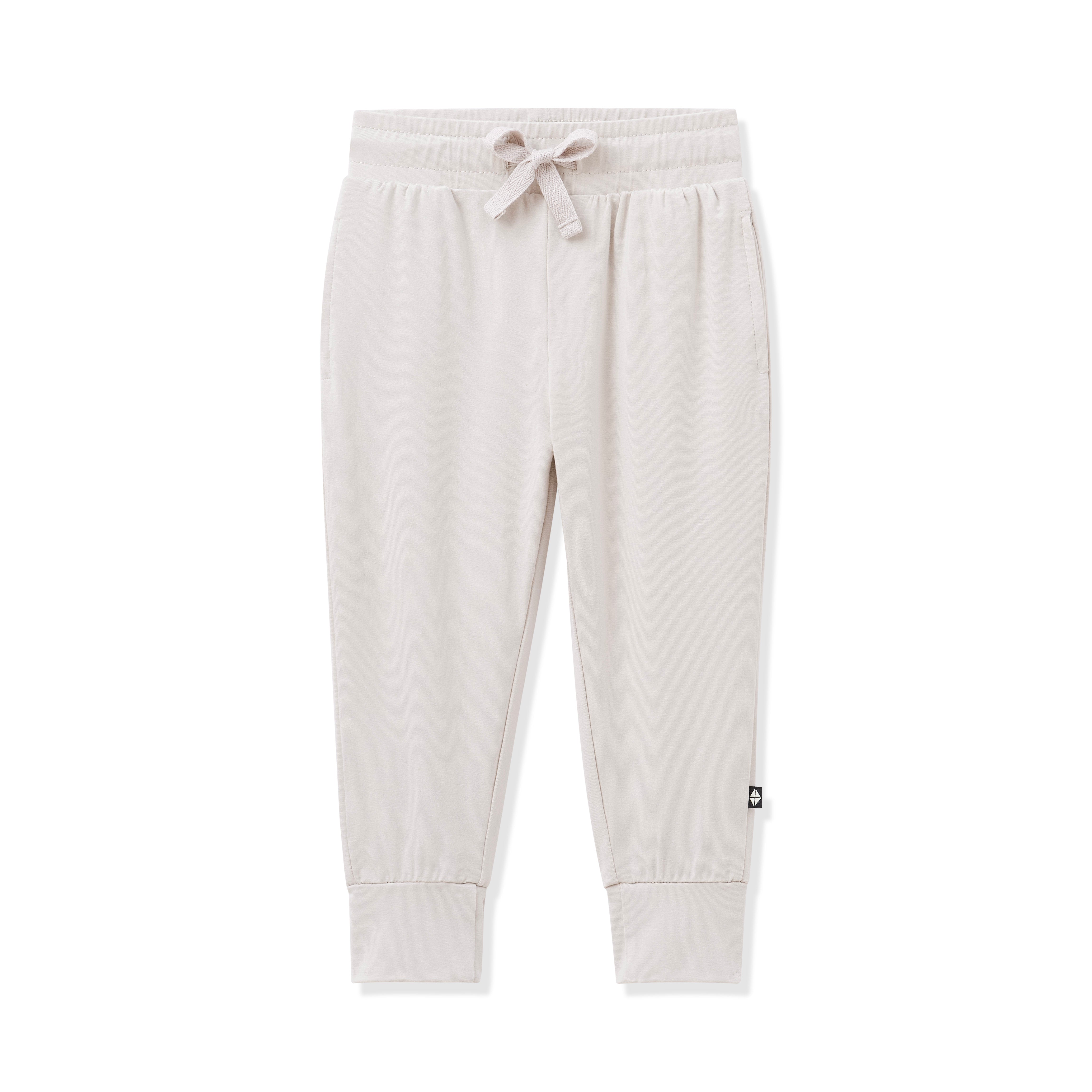 Beige sweatpants with a small logo on a white background