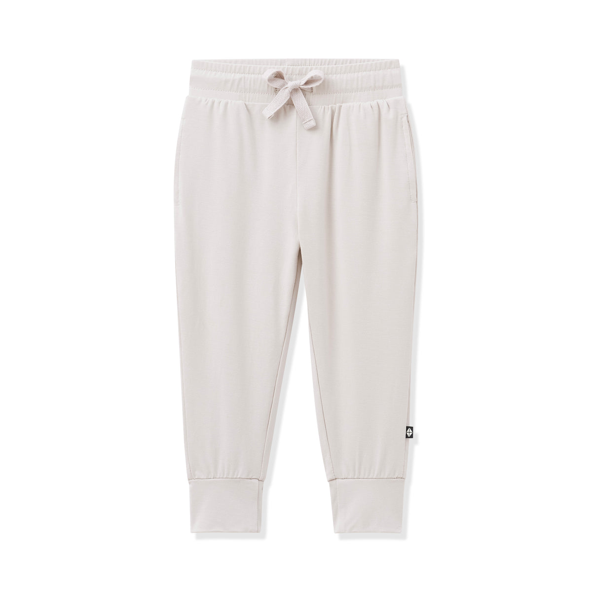 Beige sweatpants with a small logo on a white background
