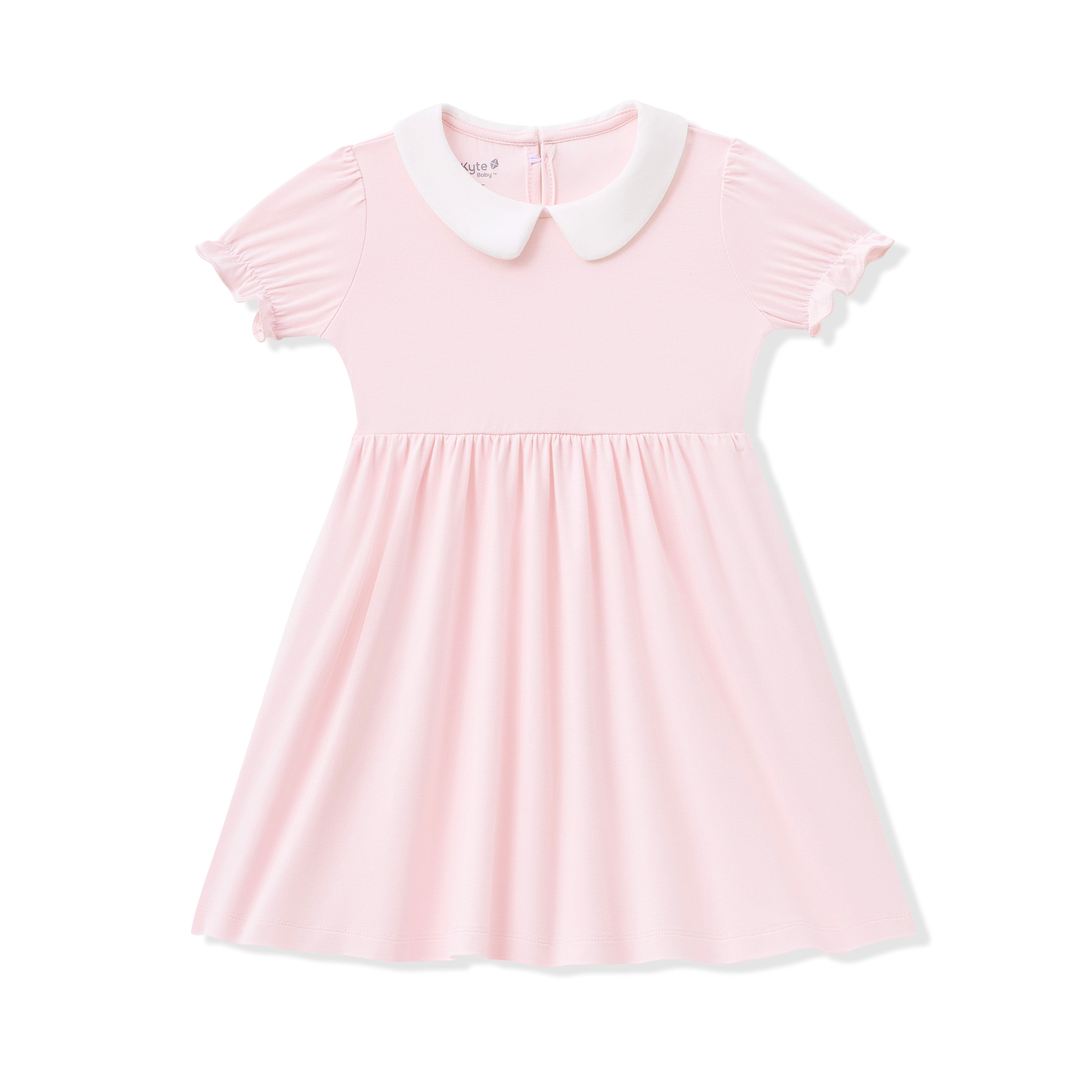 Pink dress with a white collar on a white background