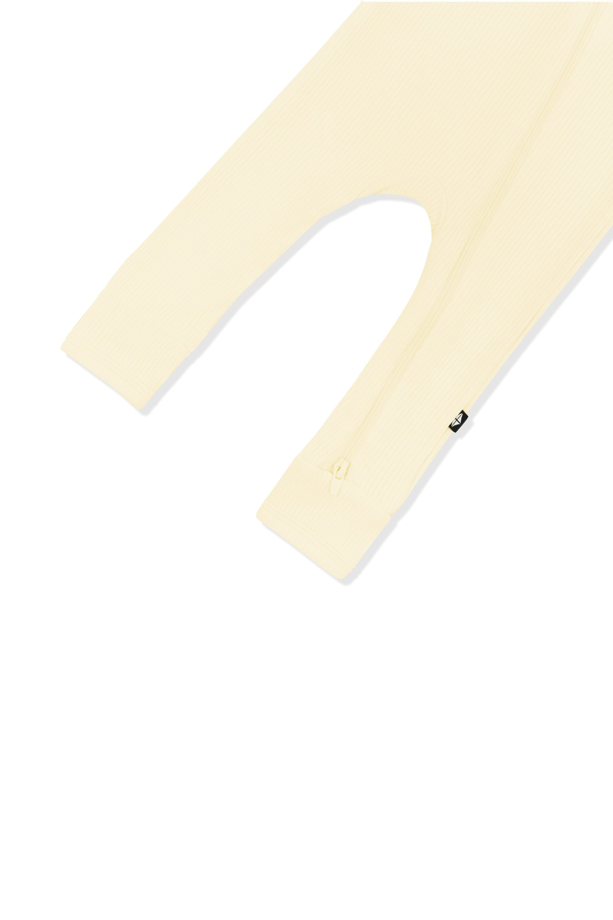 Close up of the zipper closure on the leg of the Ribbed Zipper Romper in Chamomile