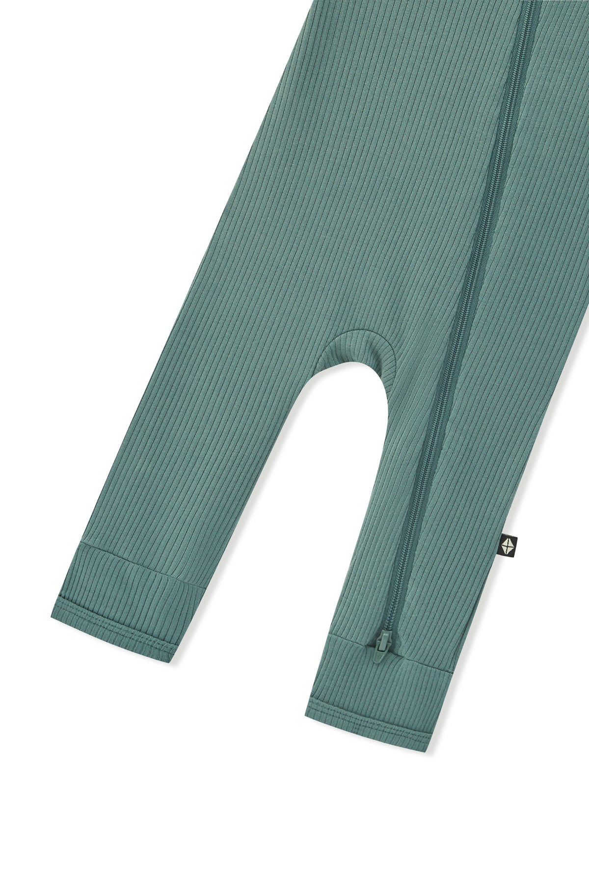 Zipper shown on the leg of the Ribbed Zipper Romper in Pine on a white background
