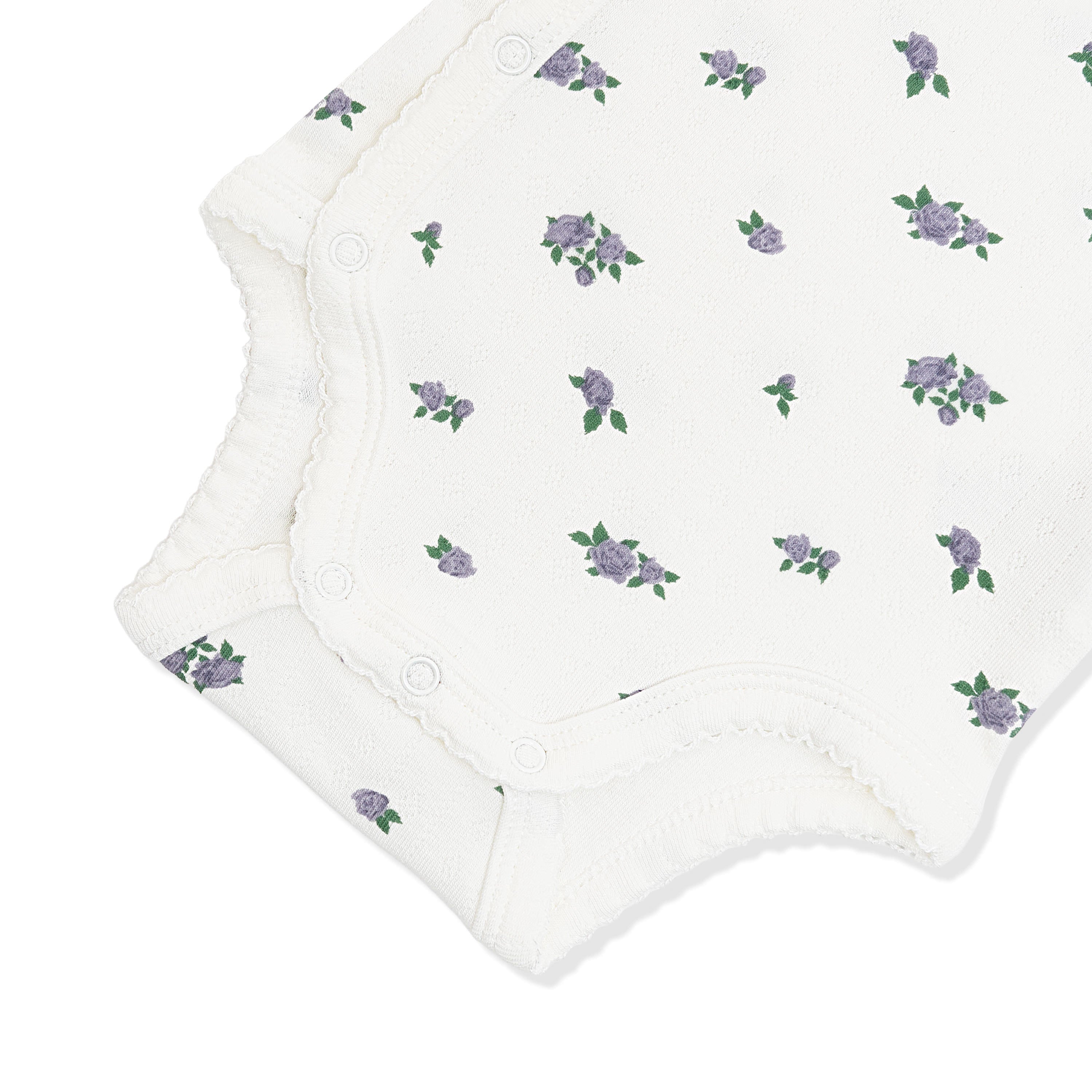 Close up of the picot trim and snap closures on the inseam shown on the Pointelle Kimono Bodysuit in Spray Rose