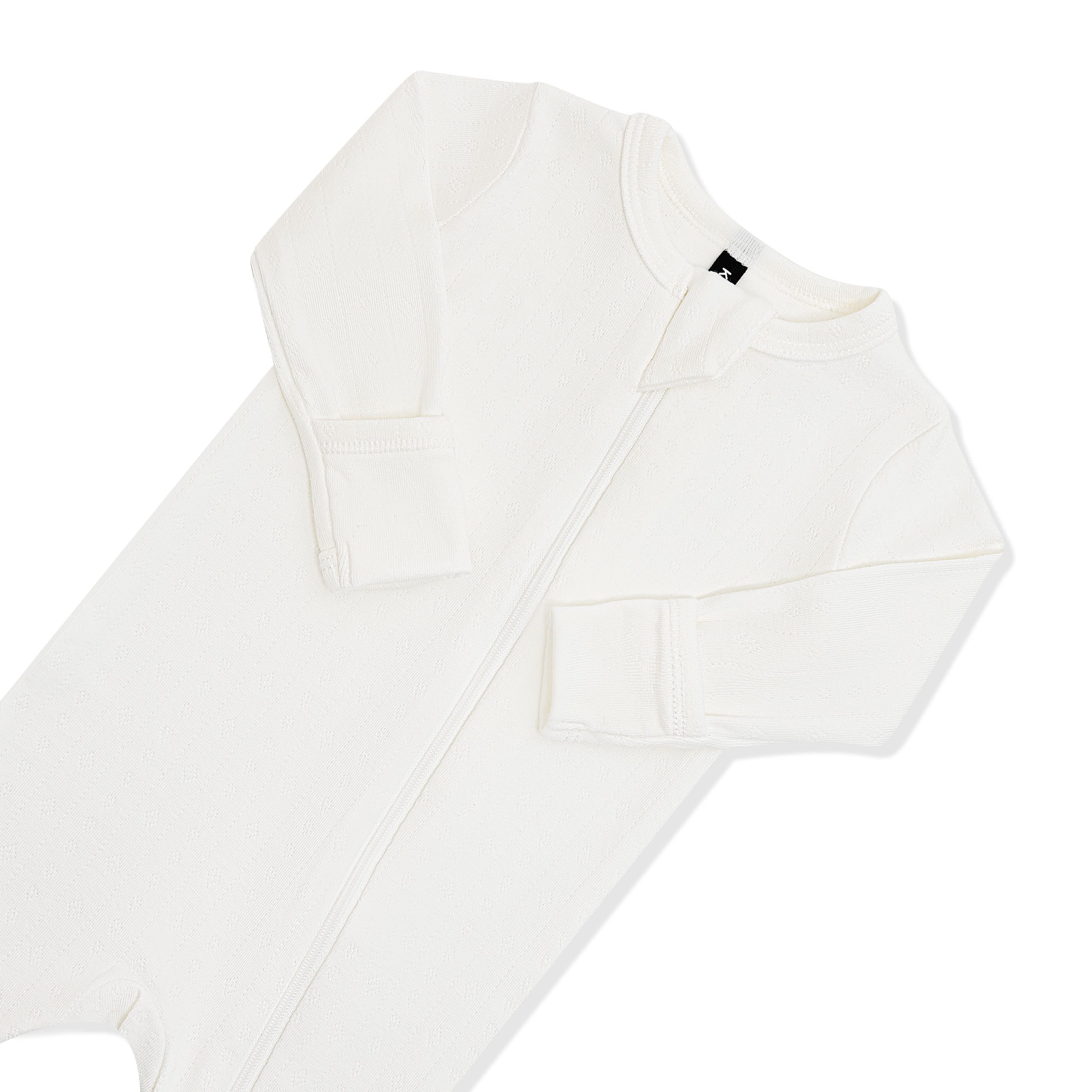 Close up of the zipper garage and fold over hand cuffs on the Pointelle Zippered Footie in Cloud