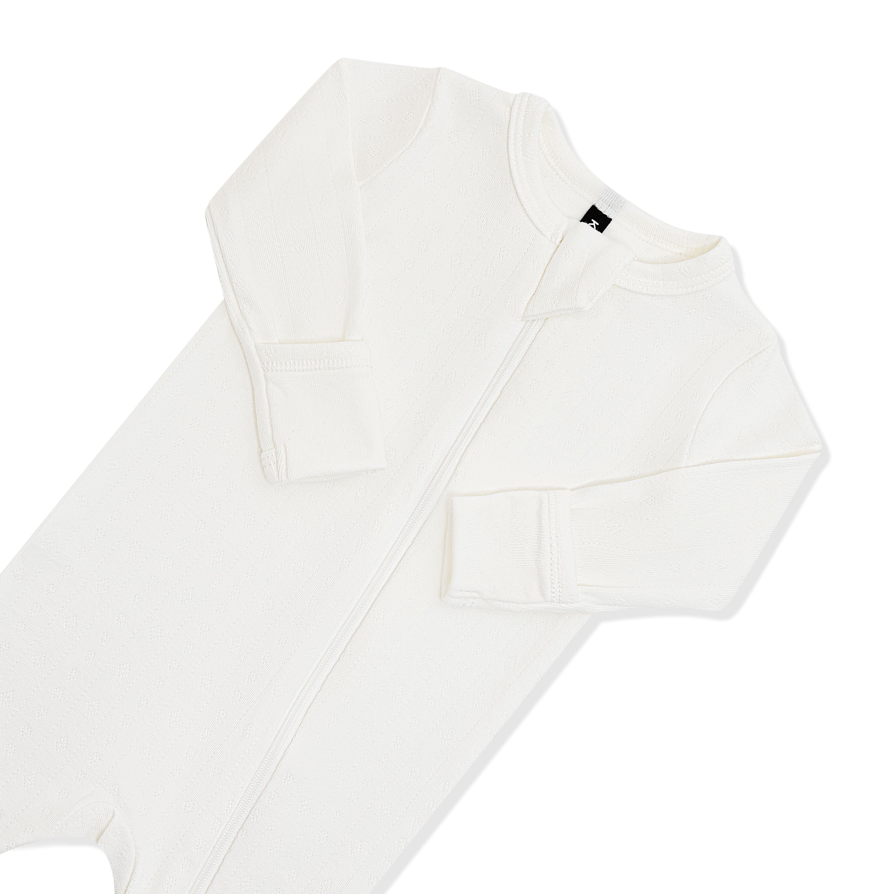 Close up of the zipper garage and fold over hand cuffs on the Pointelle Zippered Footie in Cloud