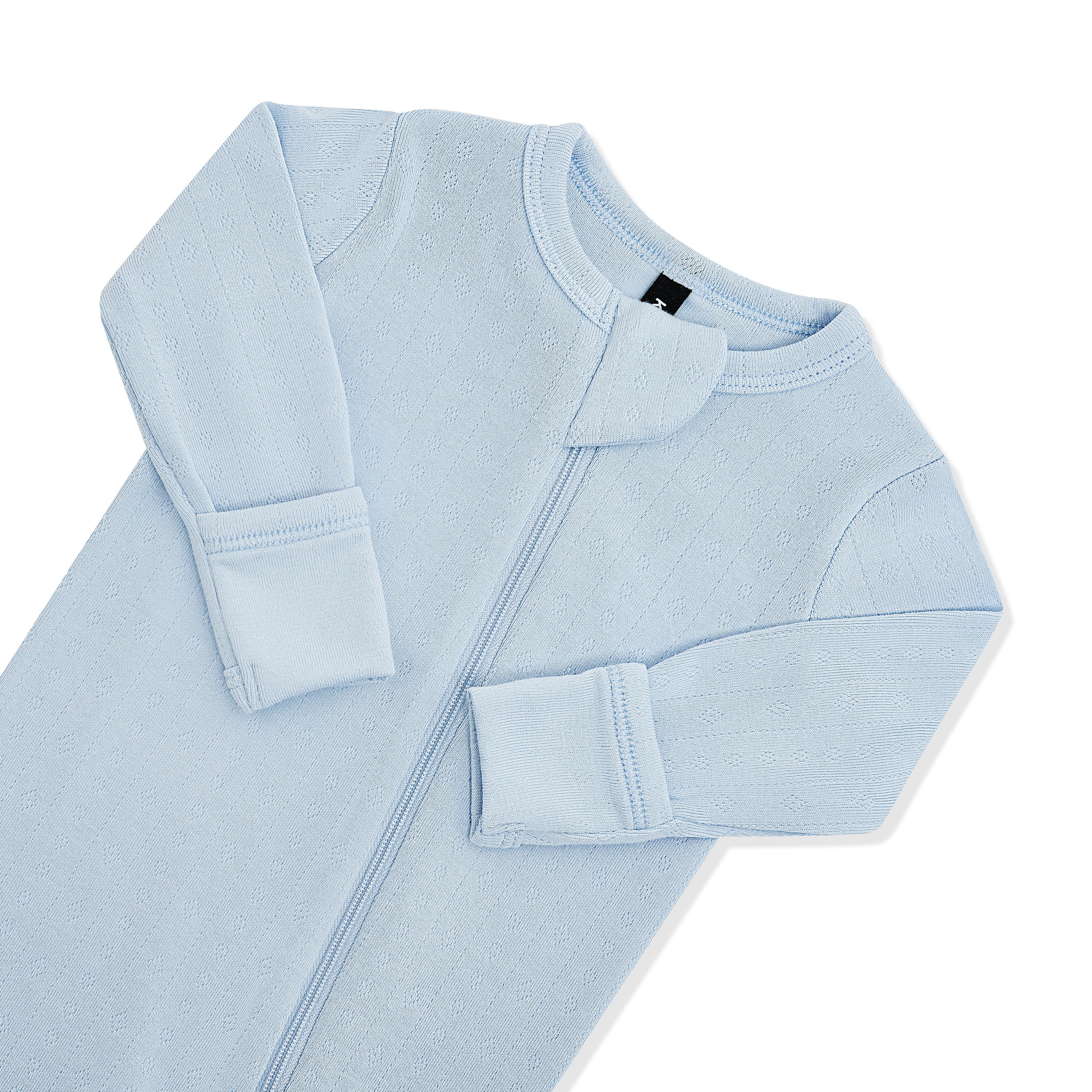 Close up of the zipper garage and fold over handcuffs on the Pointelle Zippered Footie in Breeze