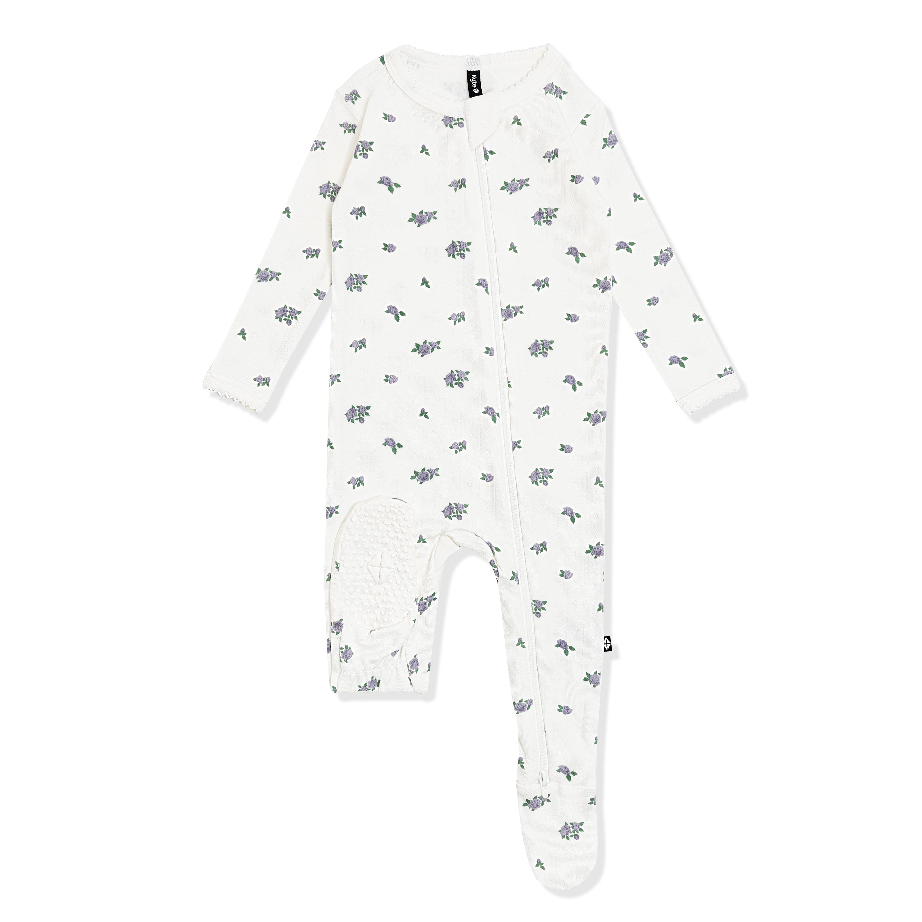 The bottom of the foot pad showing the kyte baby logo on the Pointelle Zippered Footie in Spray Rose with picot trim