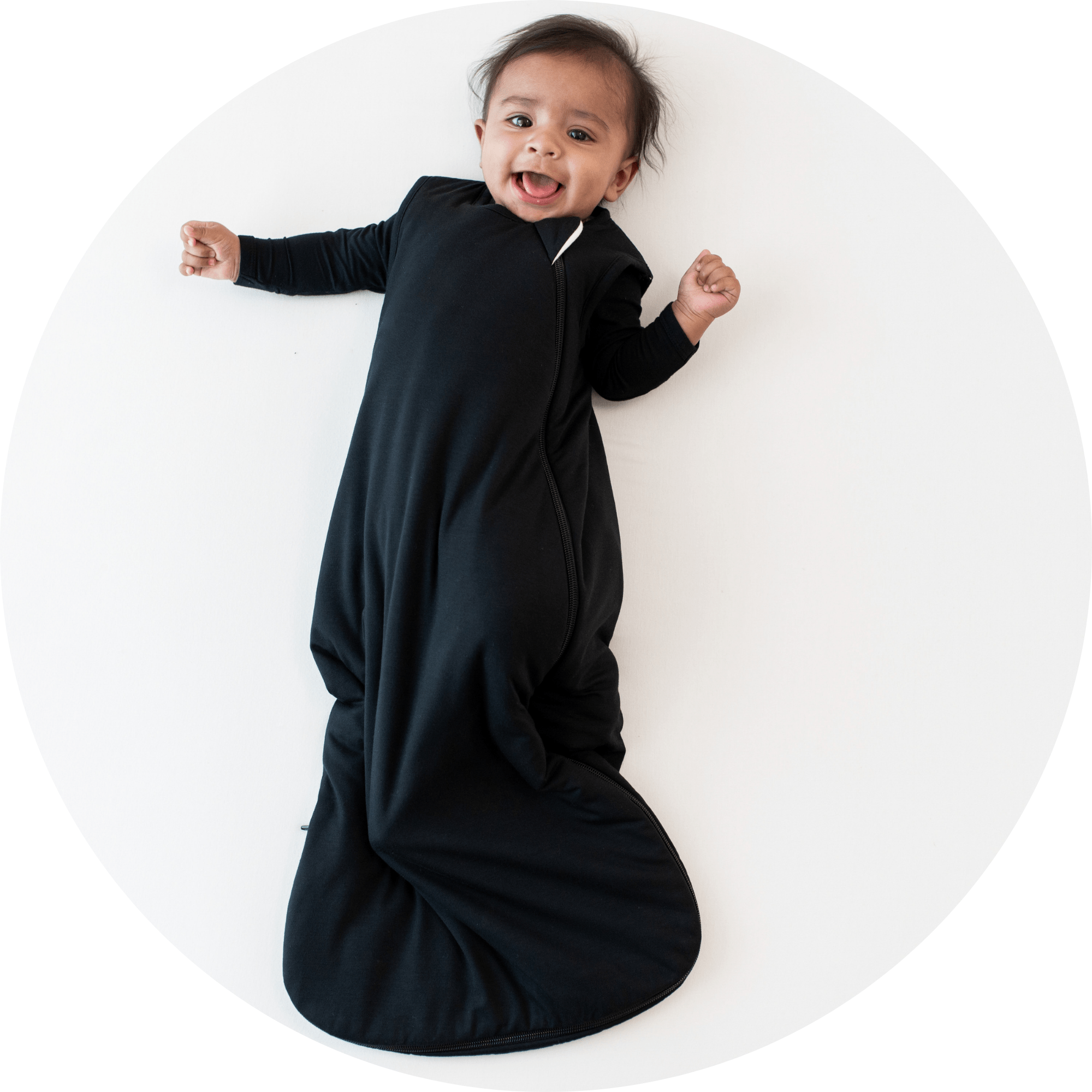 baby smiling wearing sleep bag in midnight