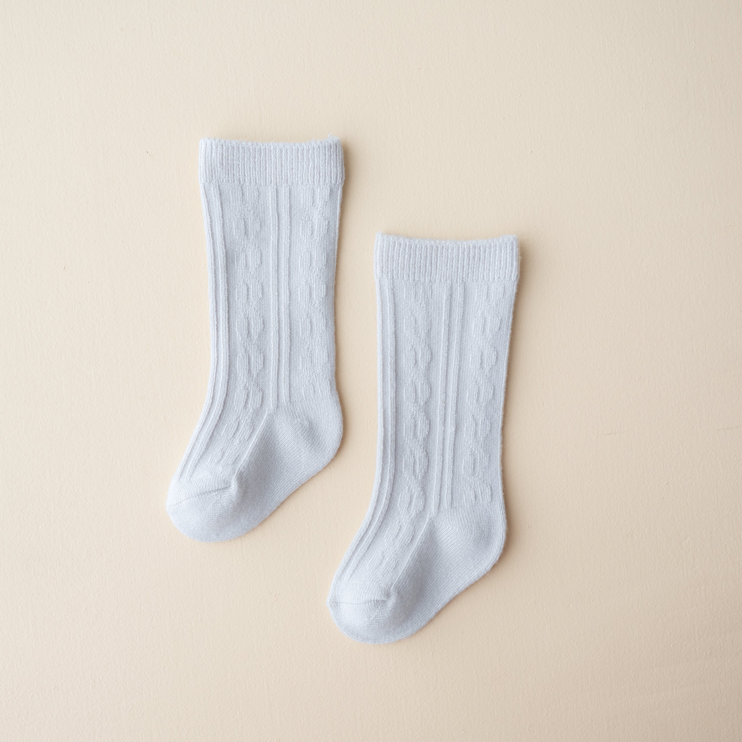 Knee High Socks in Storm shown laid out on a light neutral backdrop