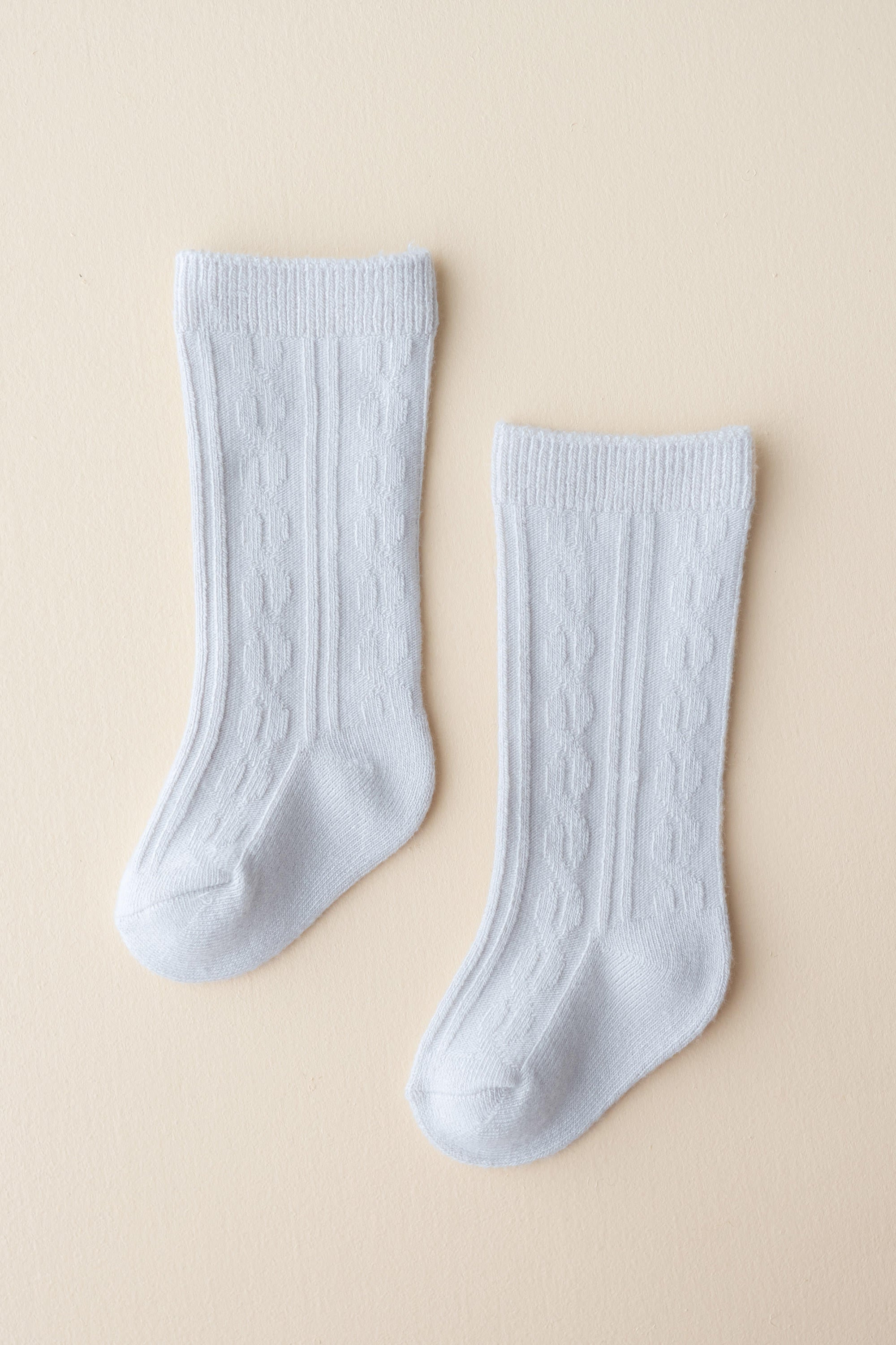 Knee High Socks in Storm shown laid out on a light neutral backdrop
