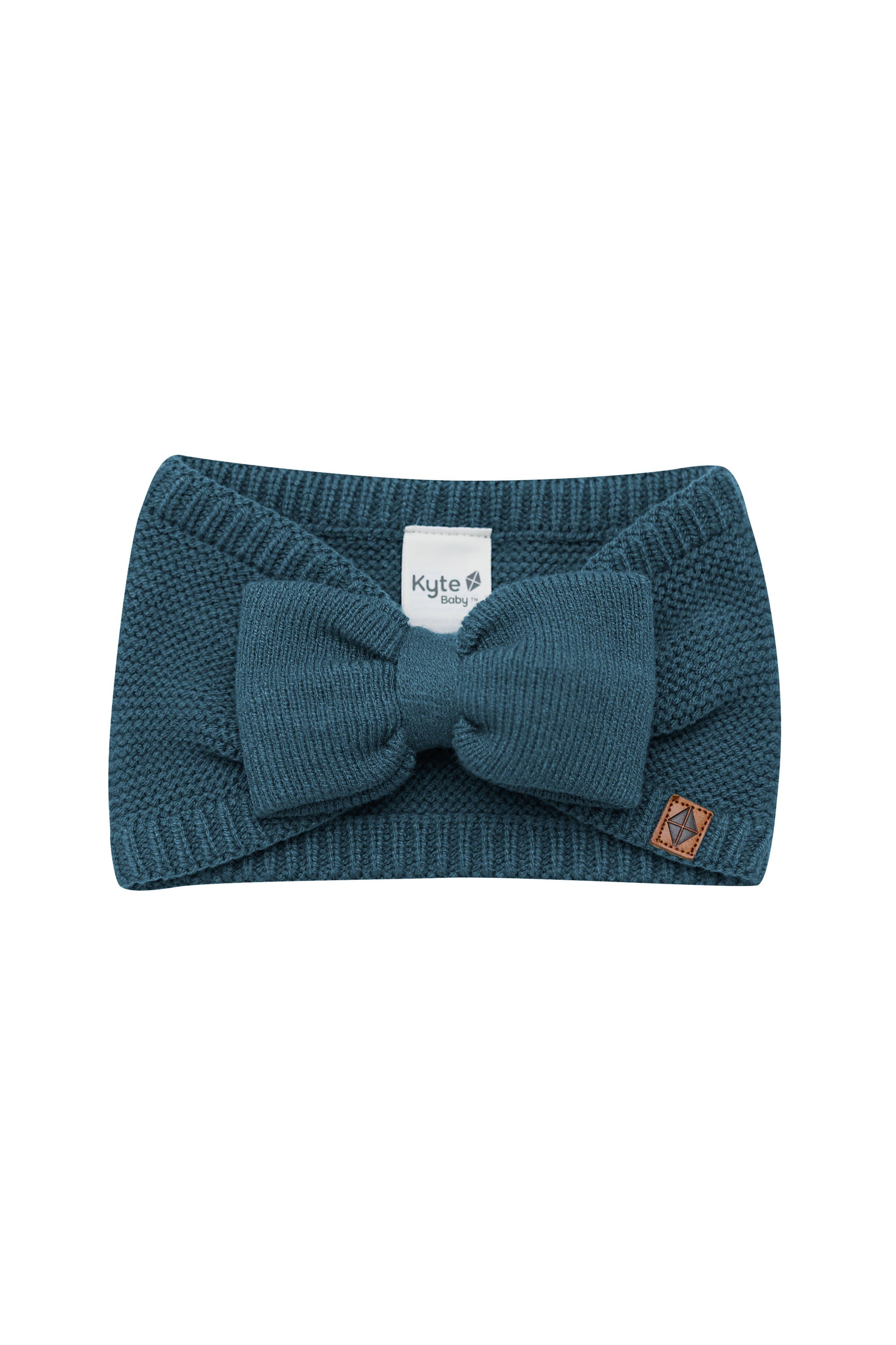 Product photo of the Chunky Knit Bow Headband in Atlantic with the Kyte Baby vegan leather tag visible