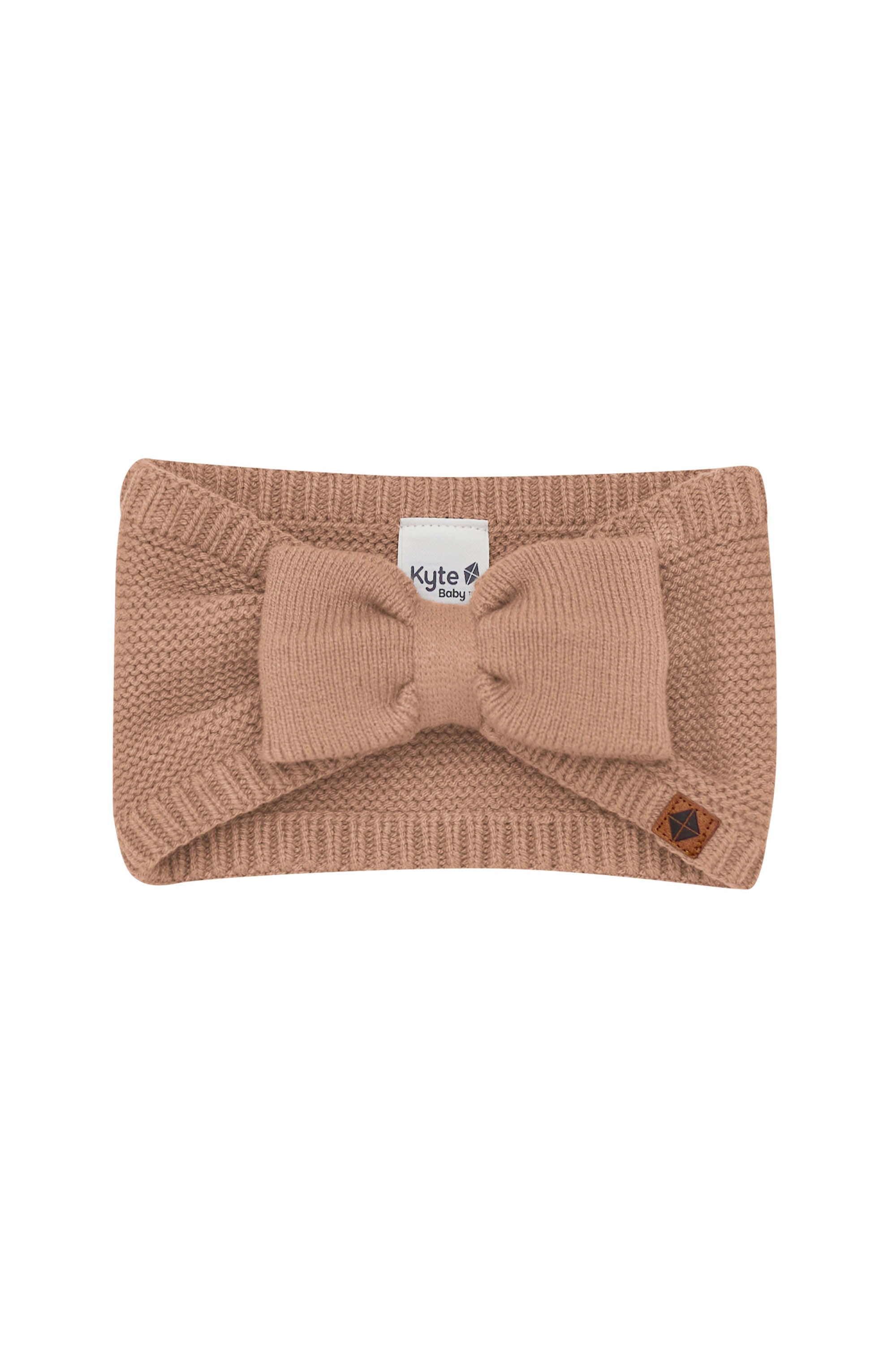 Product photo of the Chunky Knit Bow Headband in Latte with the Kyte Baby vegan leather tag visible