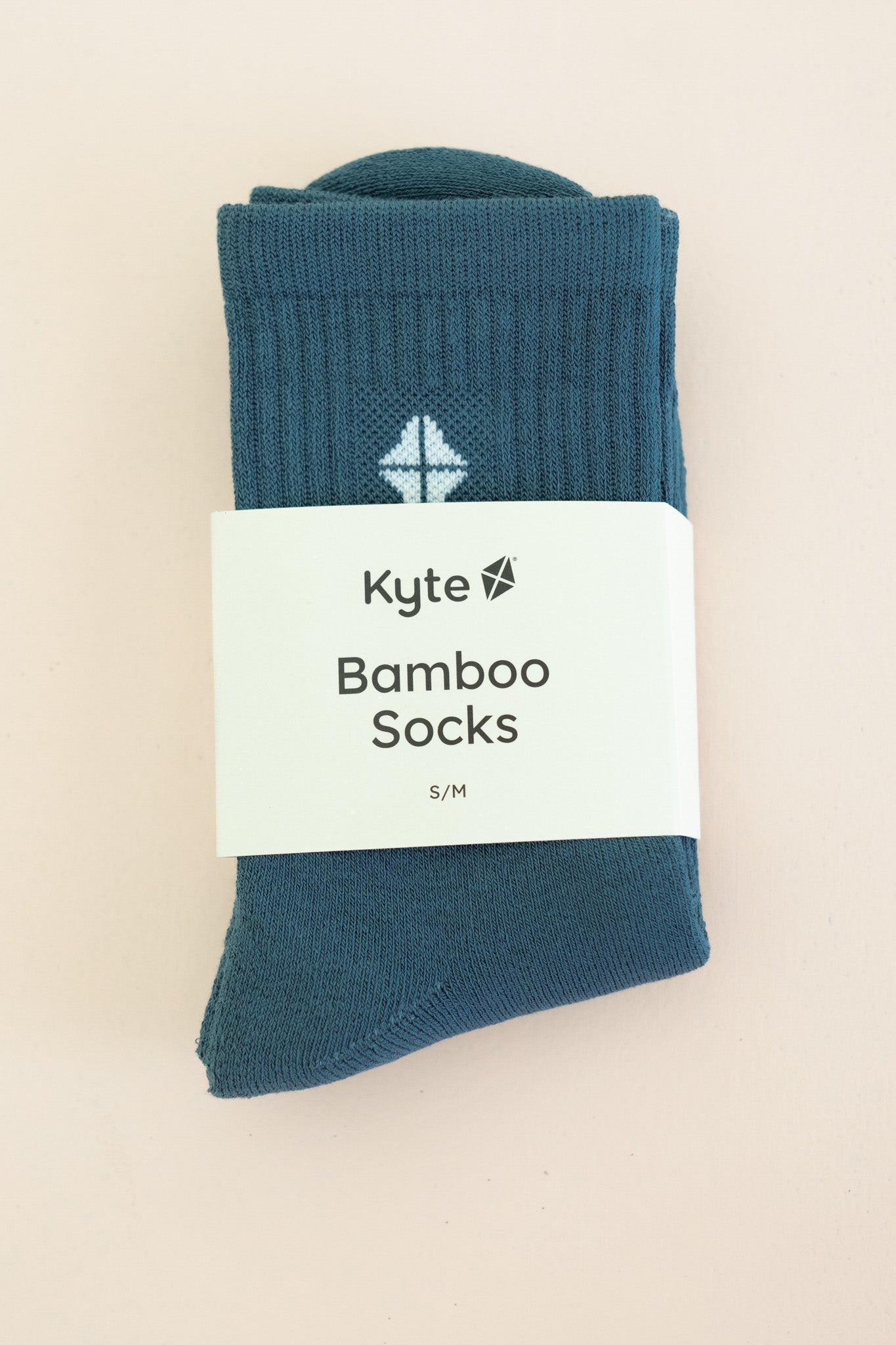 Adult Crew Socks in Atlantic shown in its packaging on a light taupe surface